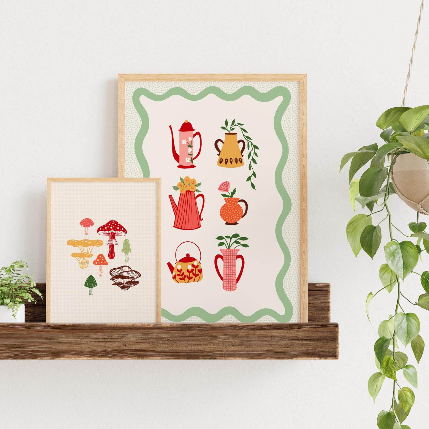 An illustrated print featuring 6 different vases and tea pots, in autumnal colours, shown in a frame. Shown next to an illustration of 7 different mushrooms.