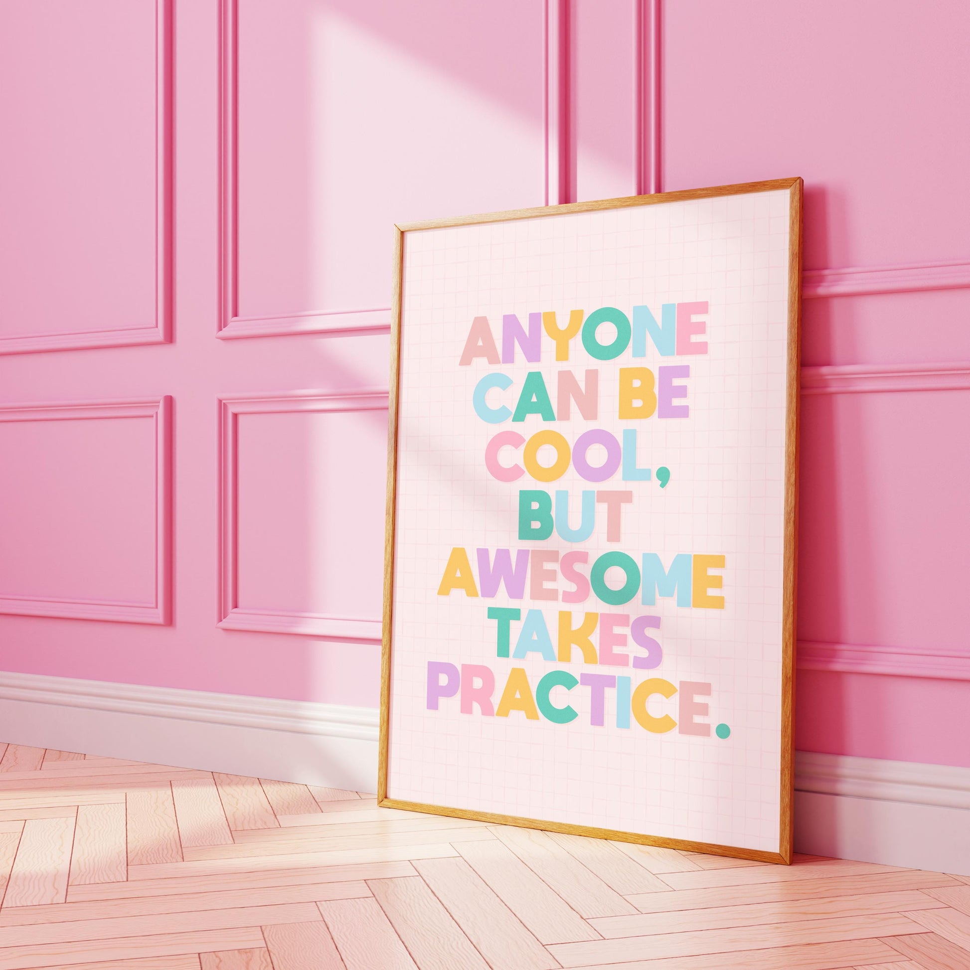 A typography print with a funny motivational quote on, in vibrant colours, shown in a frame.