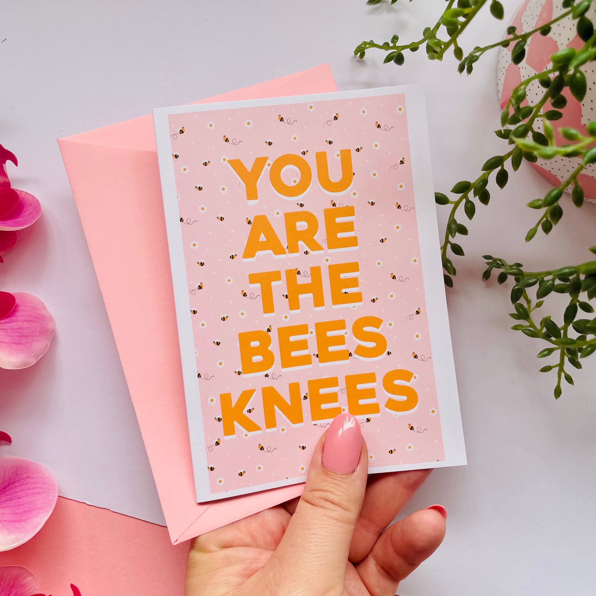 a card with a repeating pattern of buzzing bees, and text that reads 'you are the bees knees' in yellow.
