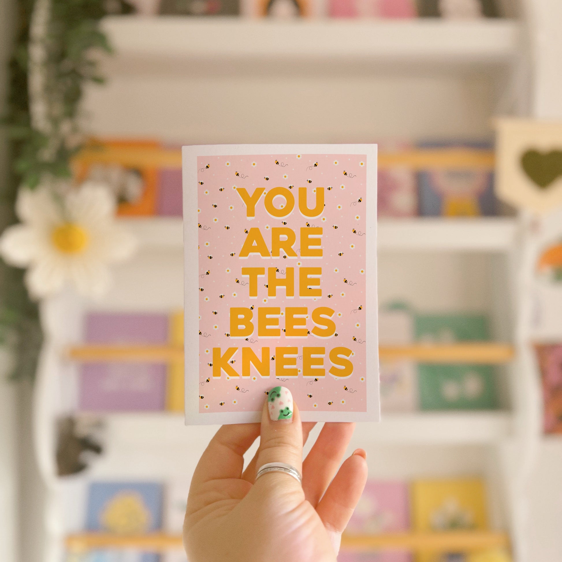 a card with a repeating pattern of buzzing bees, and text that reads 'you are the bees knees' in yellow.