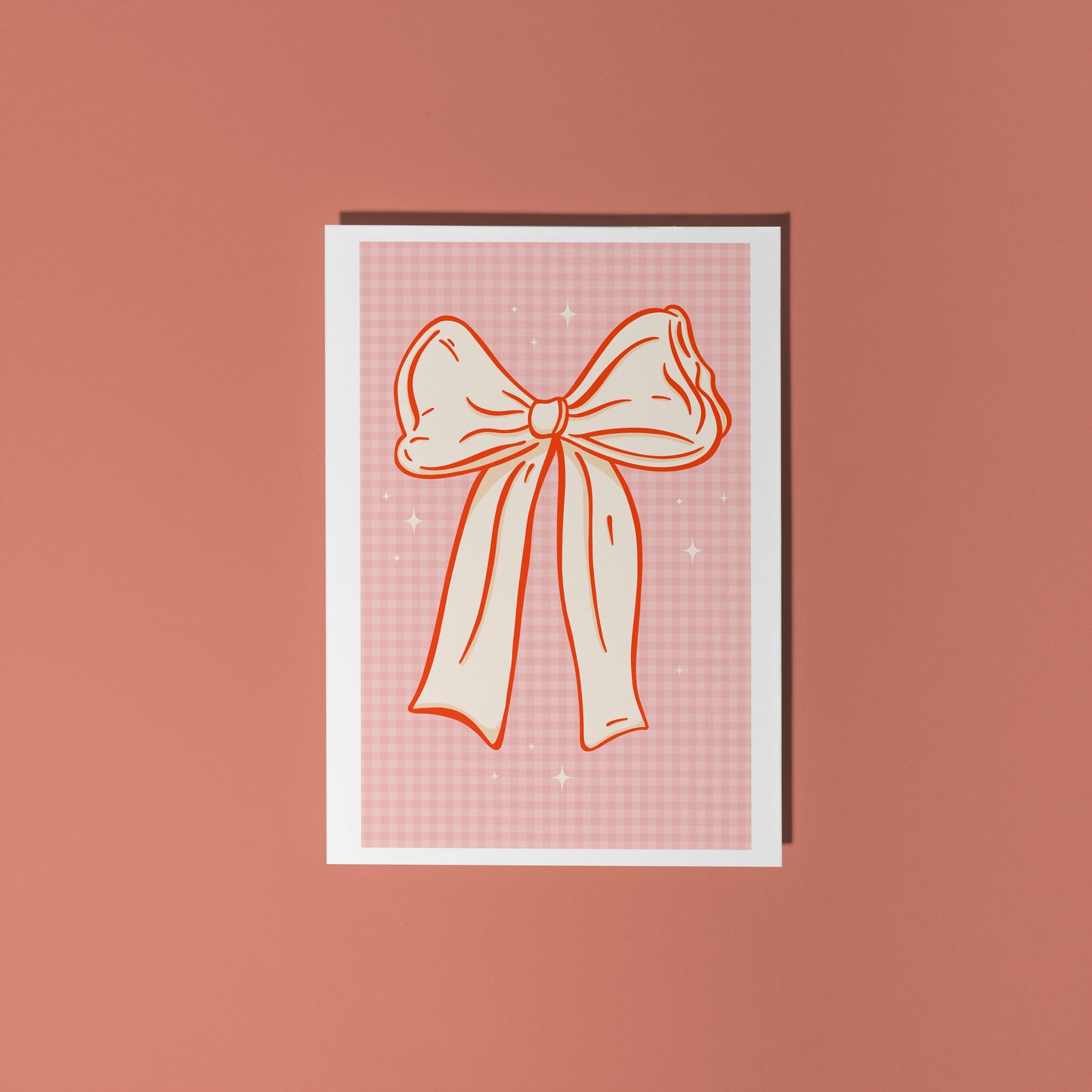 Card with a bow design on a pink background