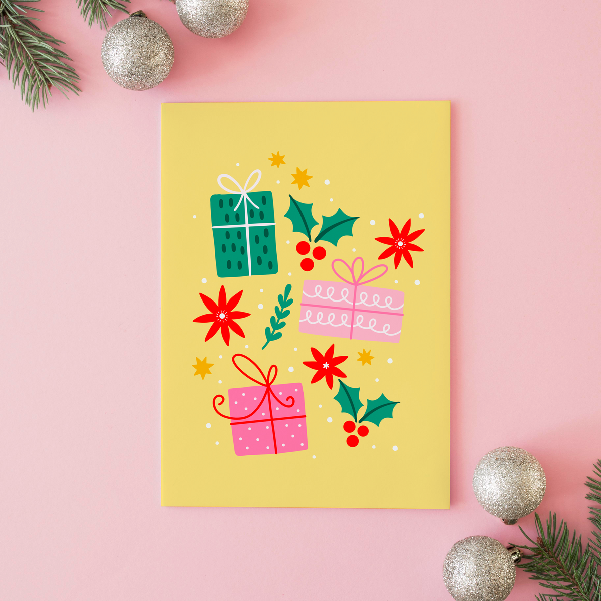 A yellow Christmas print with three brightly wrapped presents, and other small festive themes doodles.