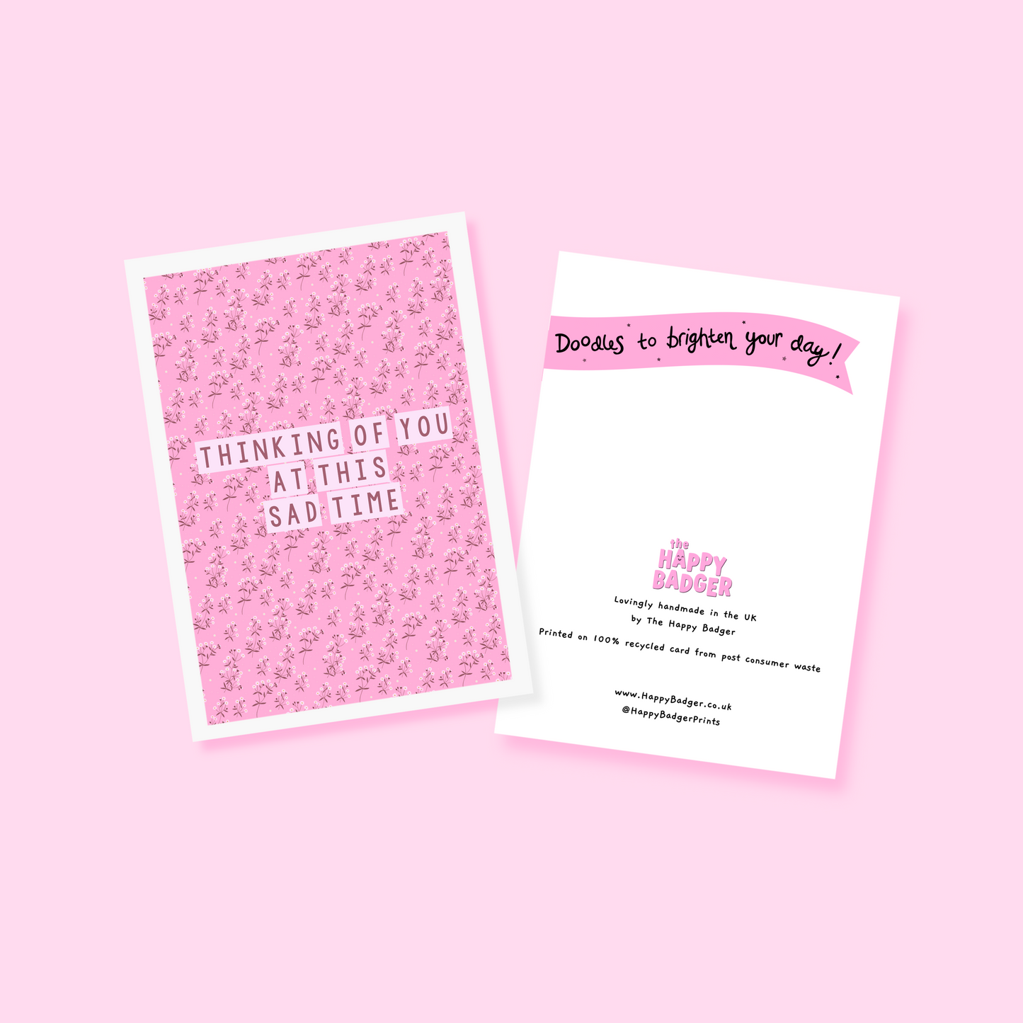 A card with a pink floral patterned background, and the words 'thinking of you at this sad time' in the centre.