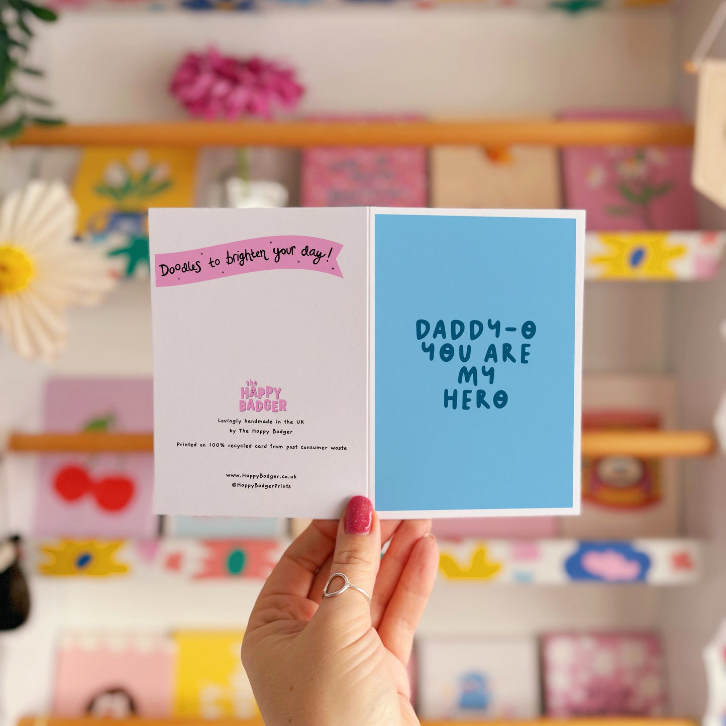 A blue greeting card with text that reads 'daddy-o you are my hero'.