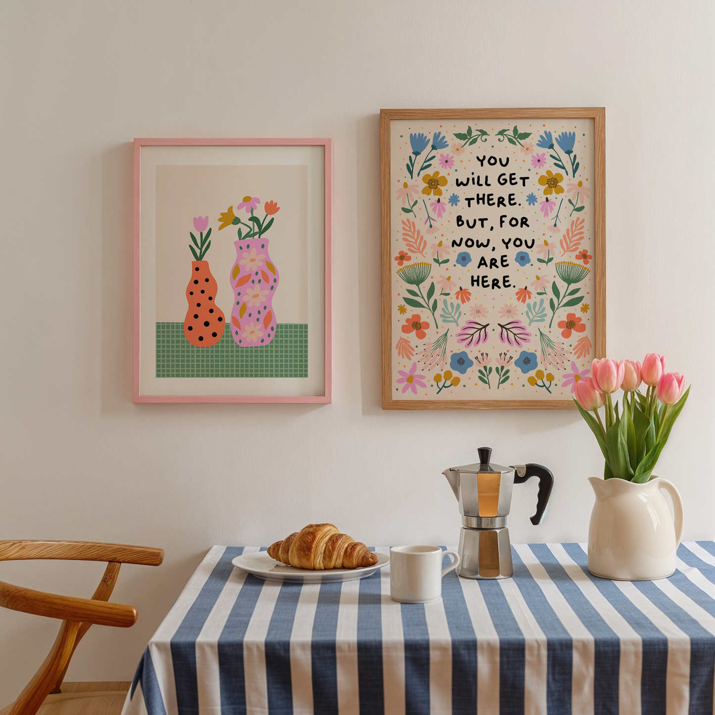A floral illustration print, drawn in a symmetrical pattern with vibrant blues, oranges and greens and pinks - surrounding a quote in black handwriting that says you will get there. but for now, you are here.