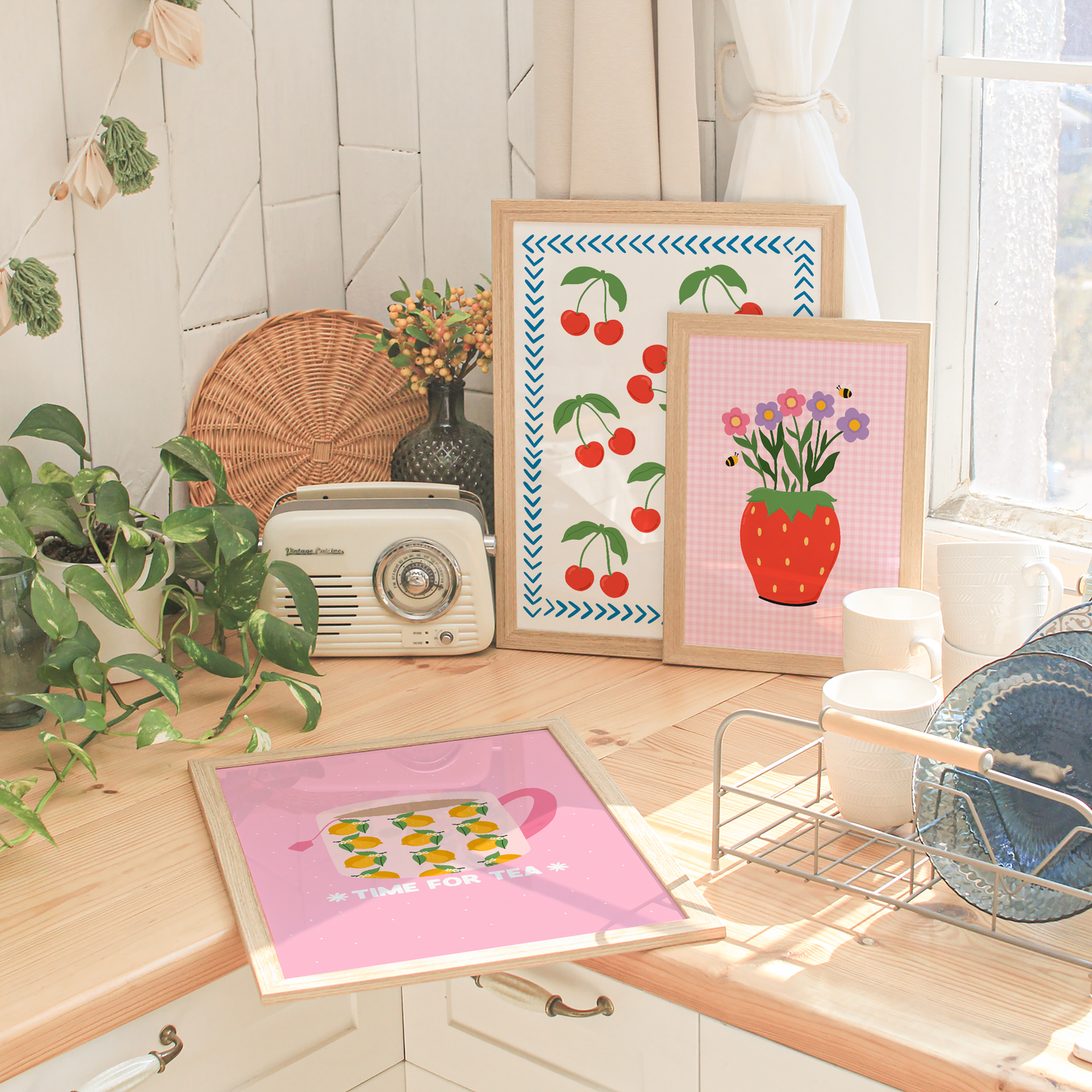 Decorative kitchen scene with framed artwork on a wooden surface.
