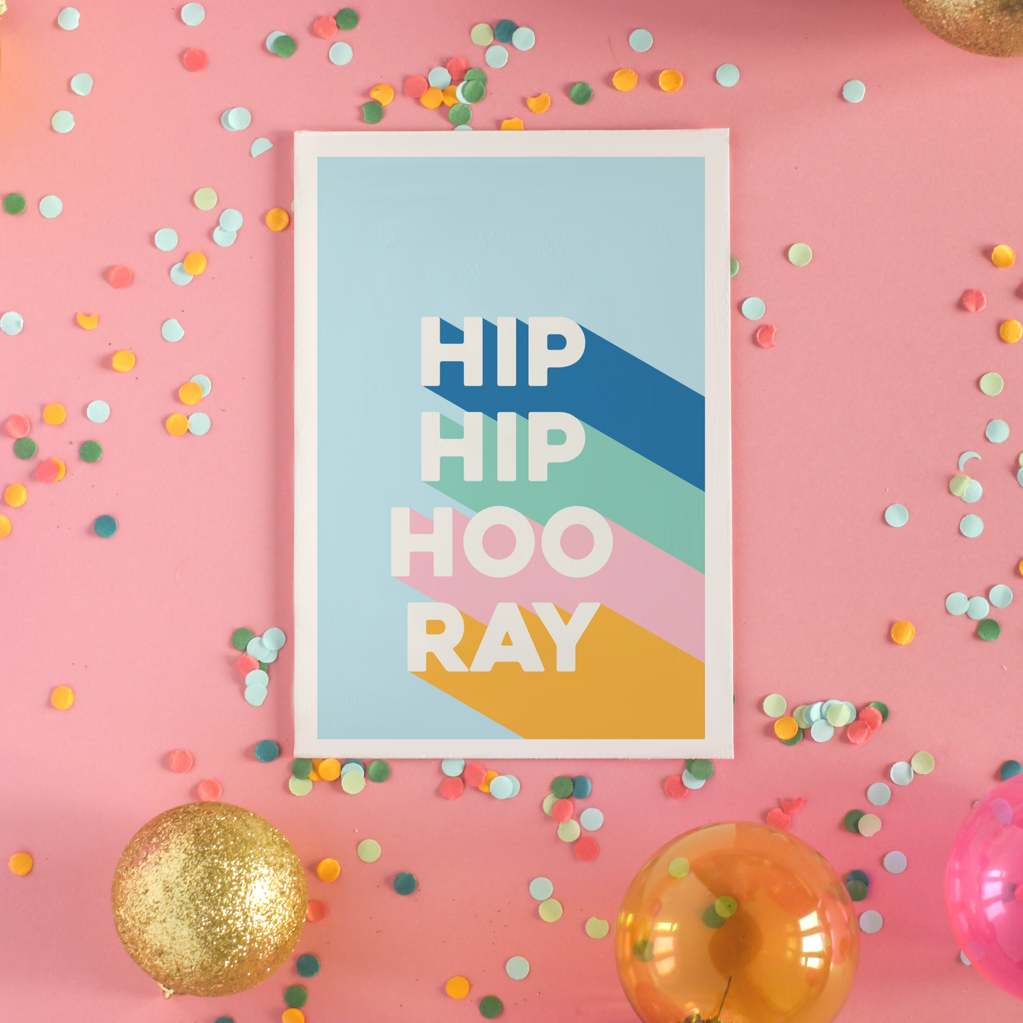 A congratulations card, saying Hip Hip Hooray in blue, green, pink and yellow.
