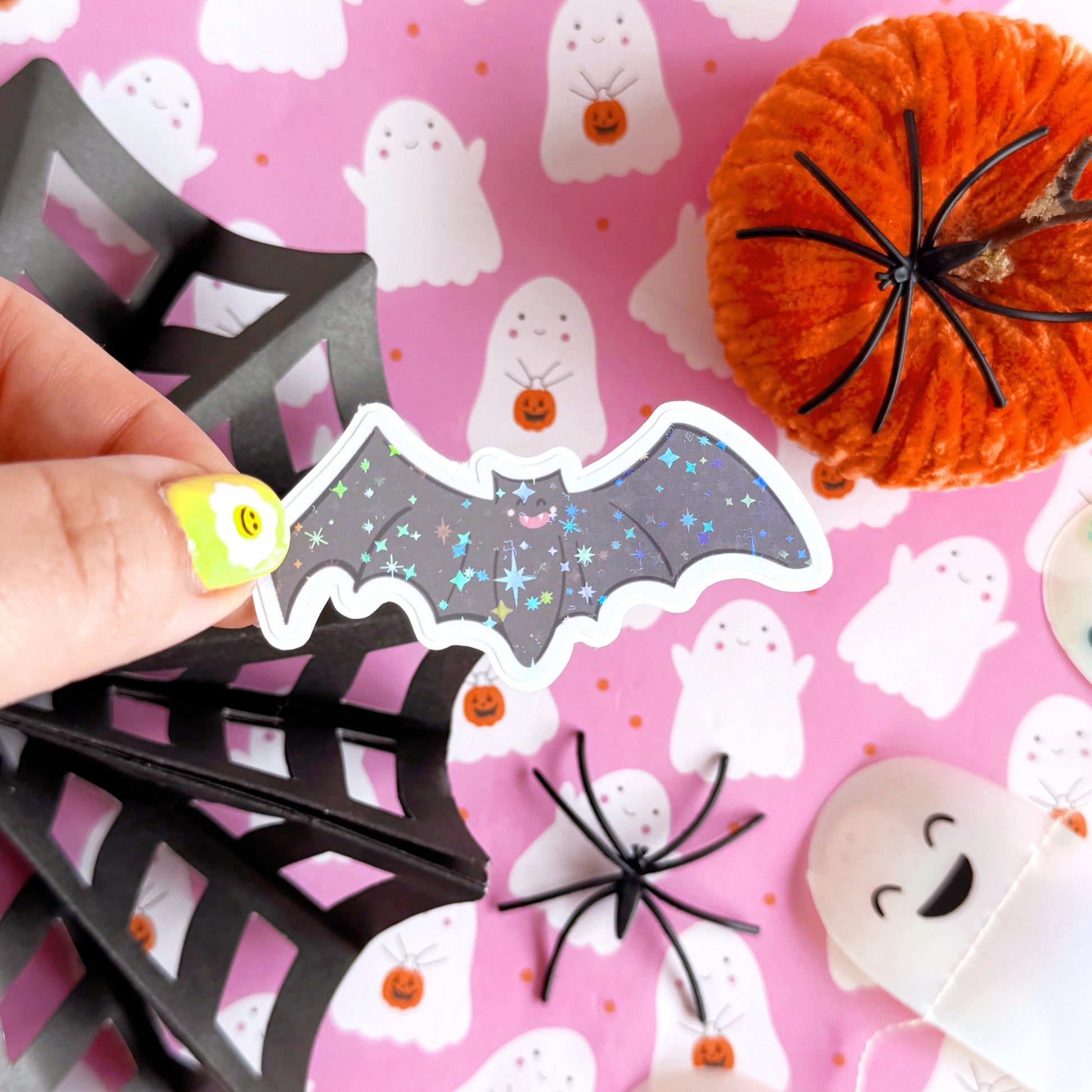 An image of a bat sticker, with a holographic finish and an easy-peel lip to detach the sticker from its backing easily.