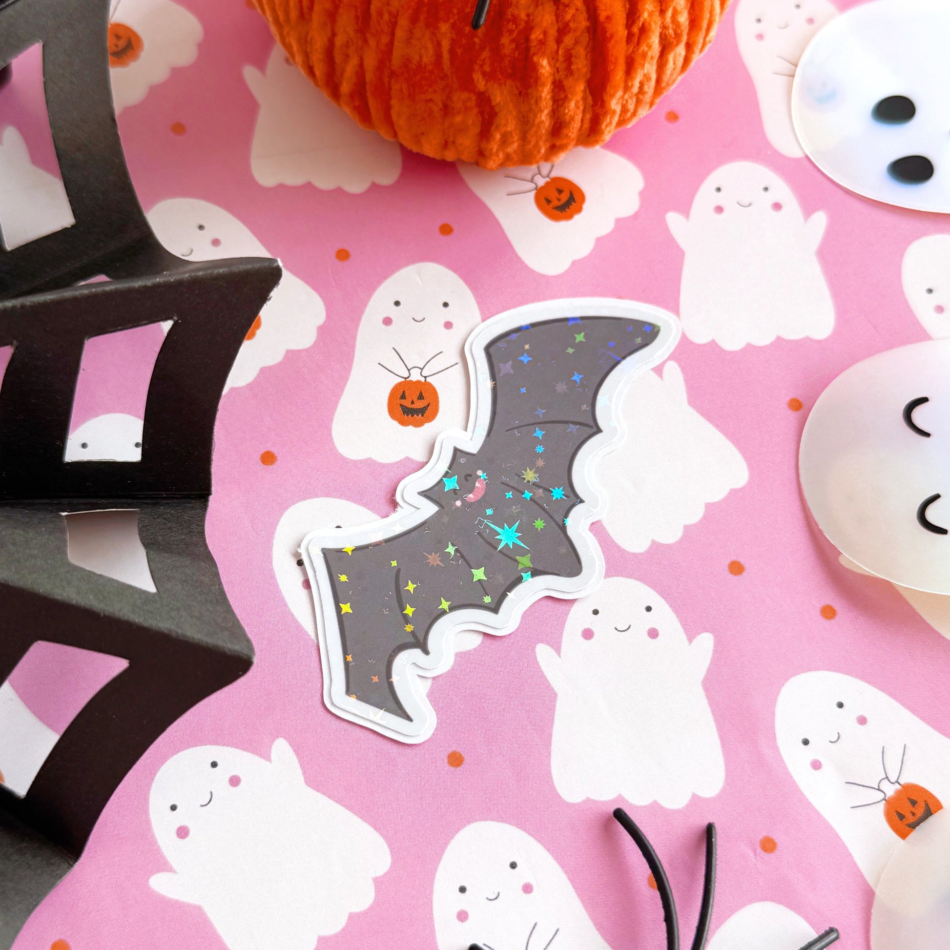 An image of a bat sticker, with a holographic finish and an easy-peel lip to detach the sticker from its backing easily.