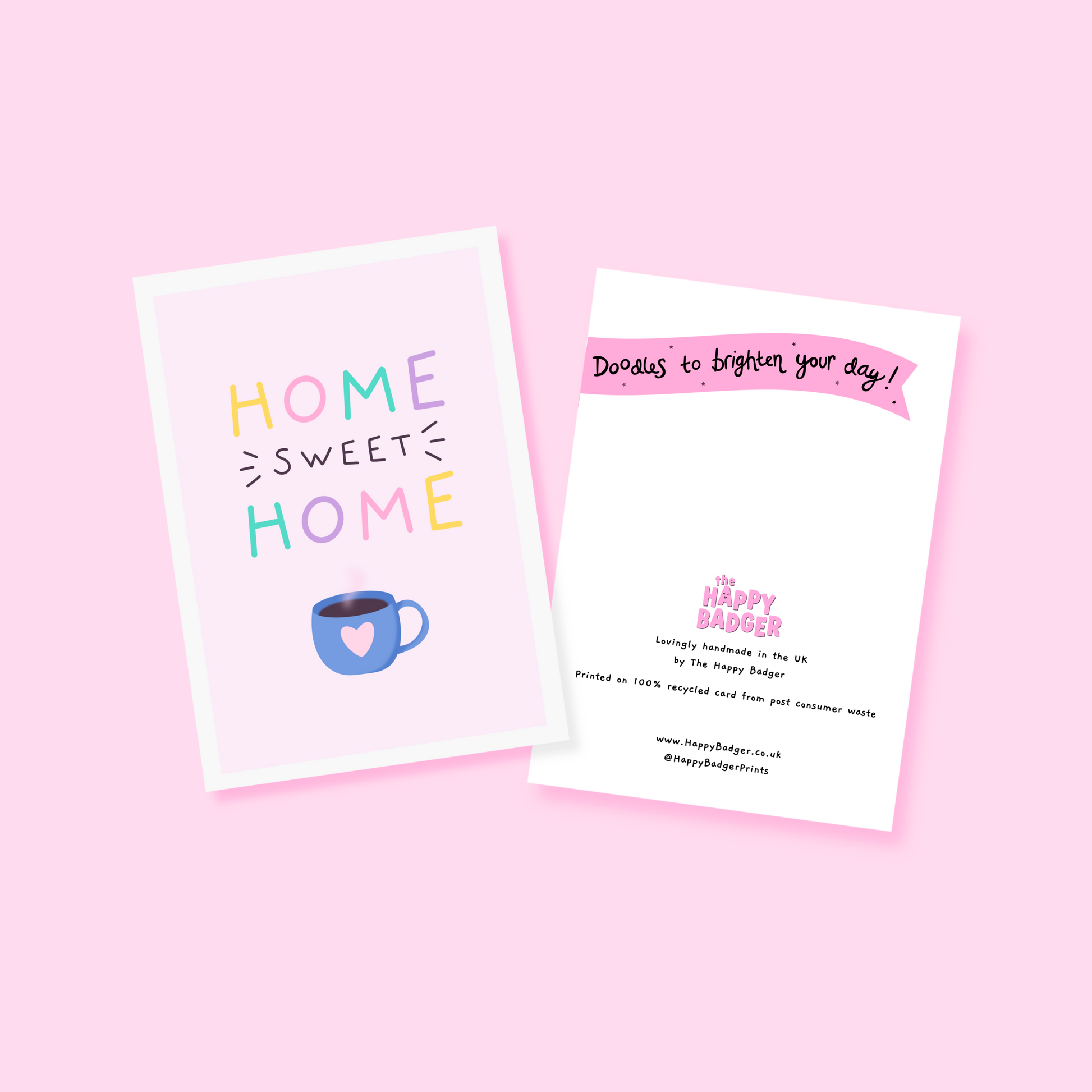a pink card with text reading 'home sweet home' and a blue mug underneath with a heart on it.