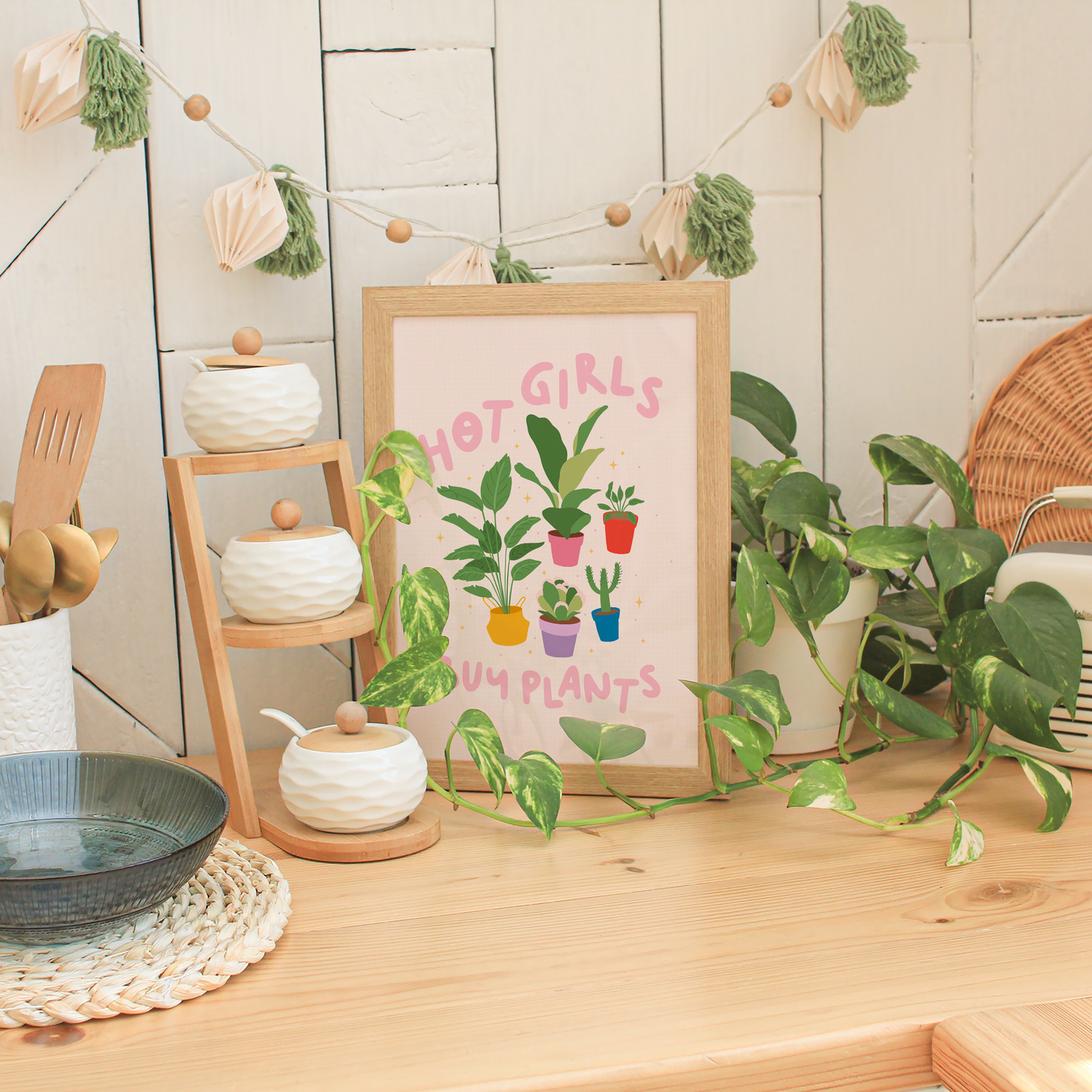 Four illustrations of potted house plants, surrounded by the words hot girls buy plants in pink text.