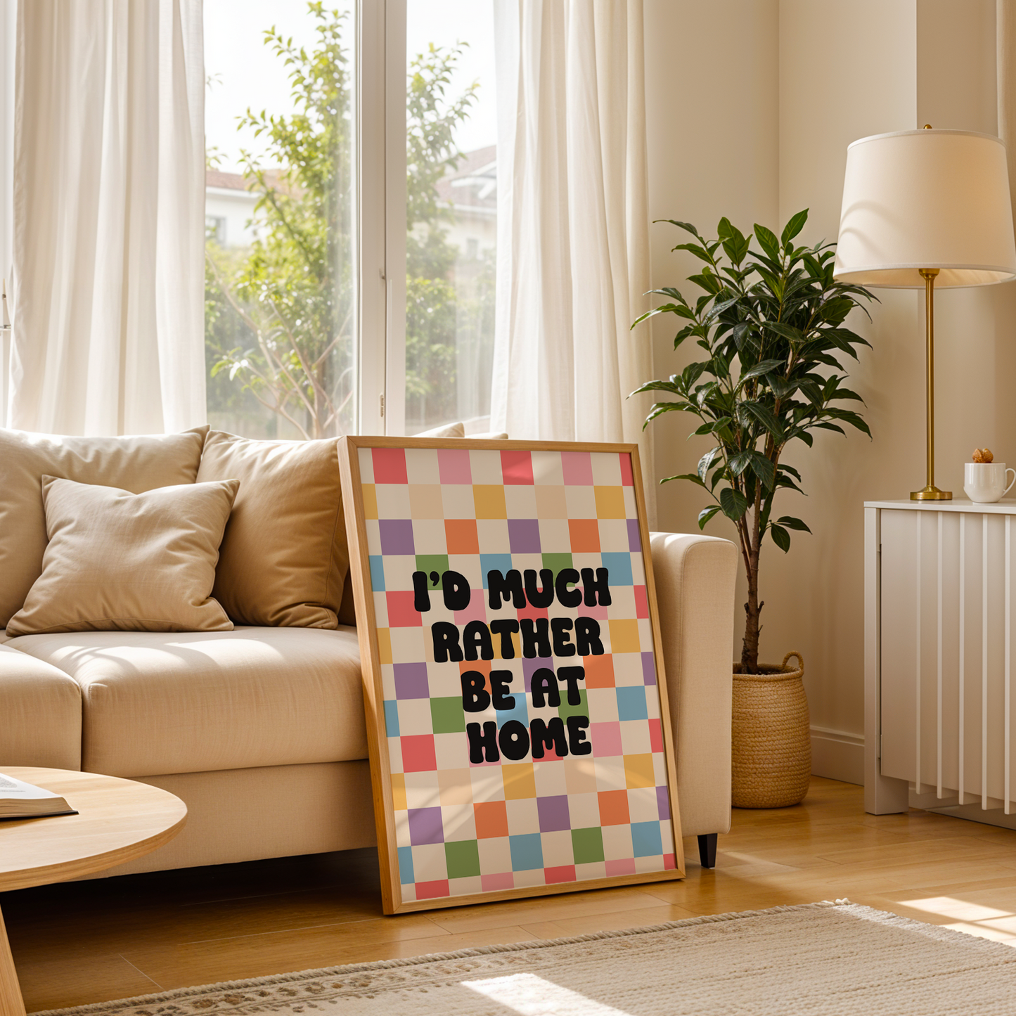 A colourful checkered print with the text 'I'd much rather be at home' centred, set against a white background.