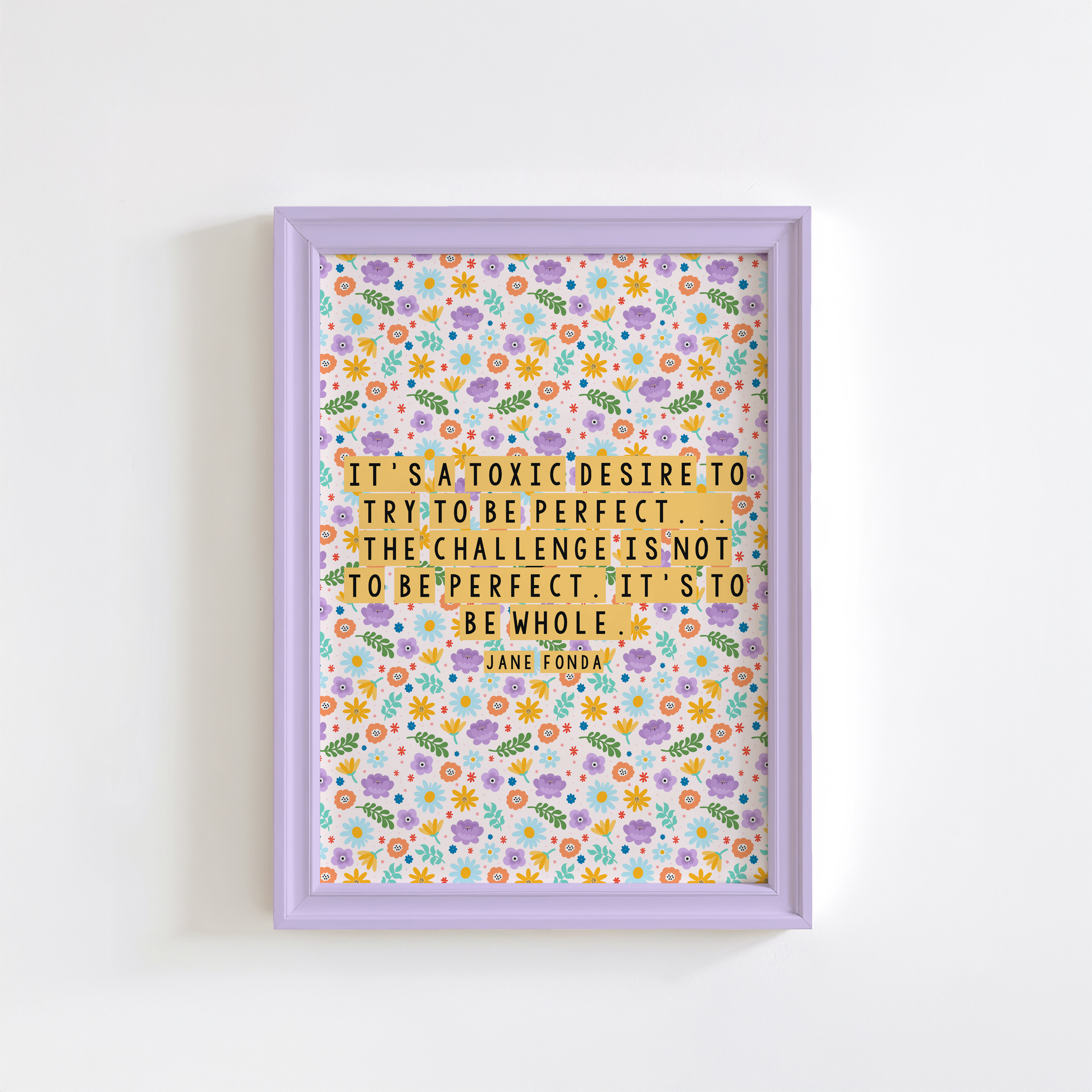 A framed print with a colourful floral pattern background featuring a quote by Jane Fonda.