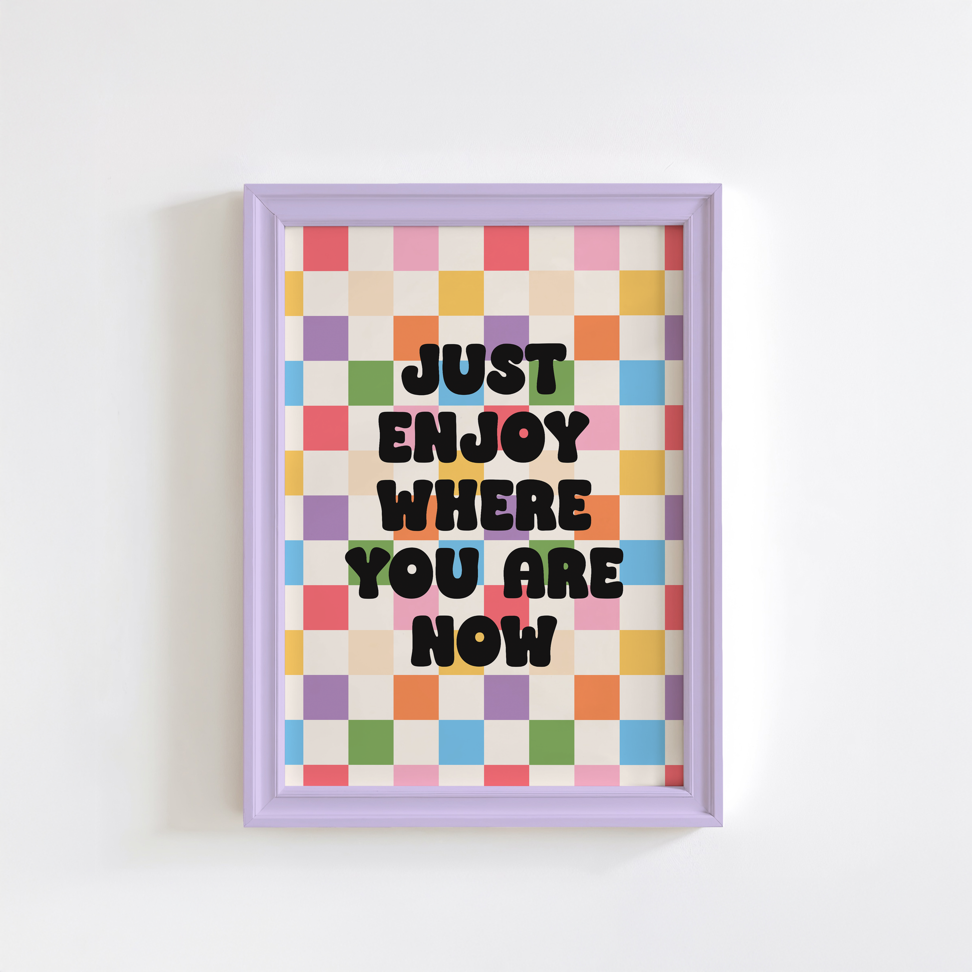 A colourful checkered background, with a quote saying "just enjoy where you are now".