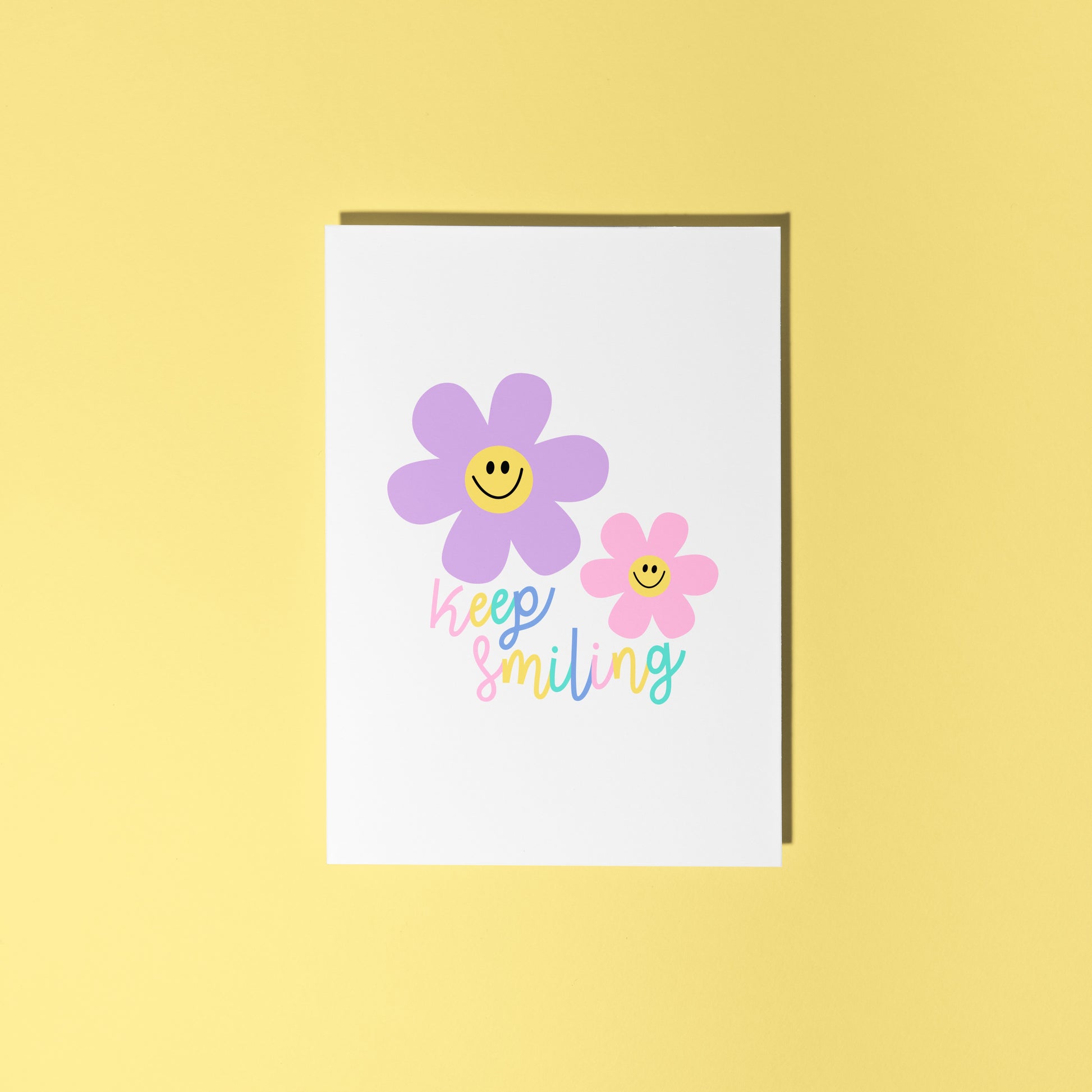 A card with two smiling flower illustrations and text that says 'keep smiling'.