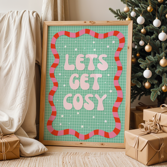 Framed poster with 'Let's Get Cosy' text in a living room with Christmas decorations.