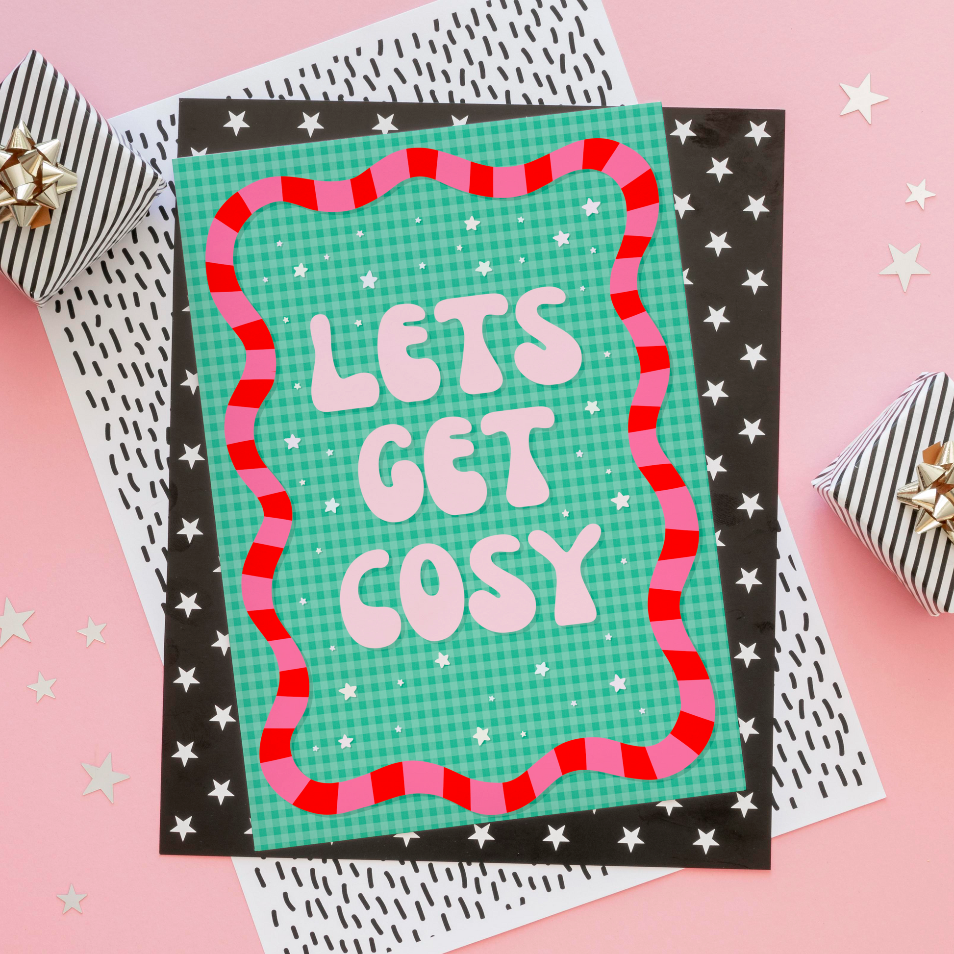 Print with 'Let's Get Cosy' text on a pink background with decorative elements