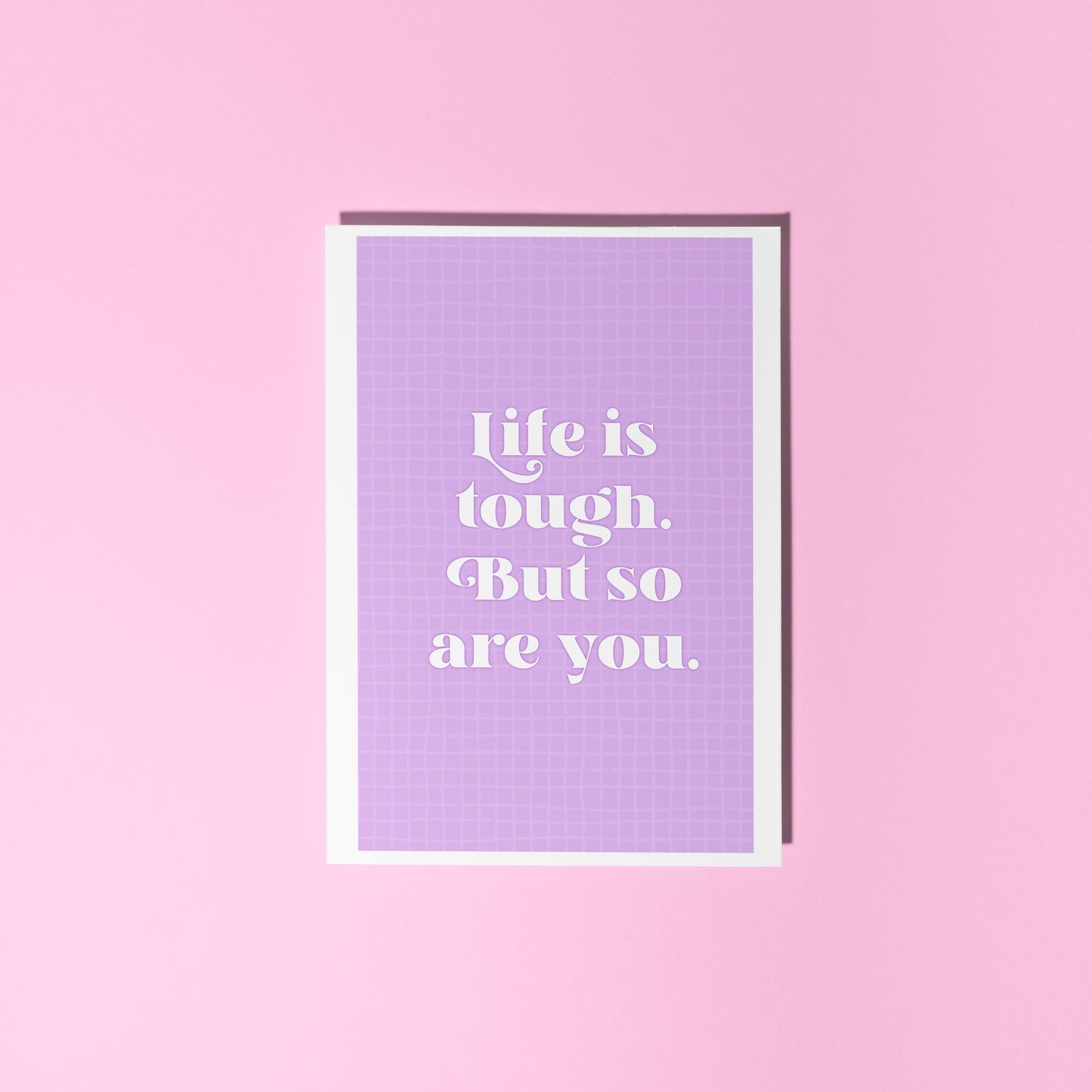 A purple card, with the quote 'life is tough, but so are you' on the front.