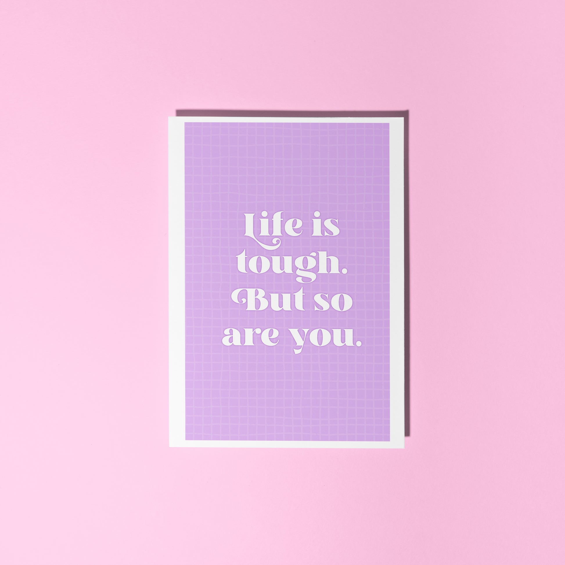 A purple card, with the quote 'life is tough, but so are you' on the front.