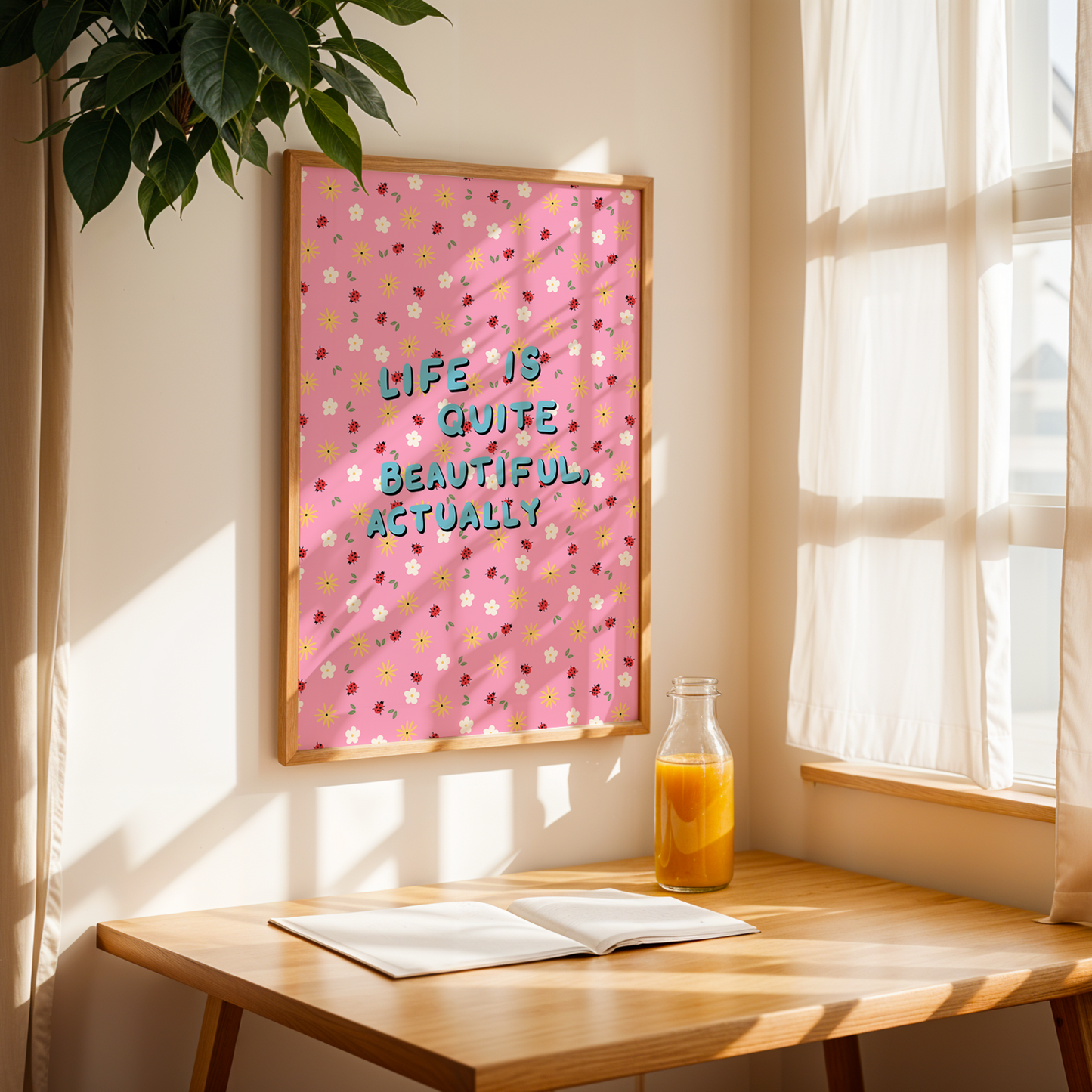 A pink patterned print, with little white and yellow flowers and small lady birds. In the centre of the print in handwriting, are the words 'life is quite beautiful, actually'.