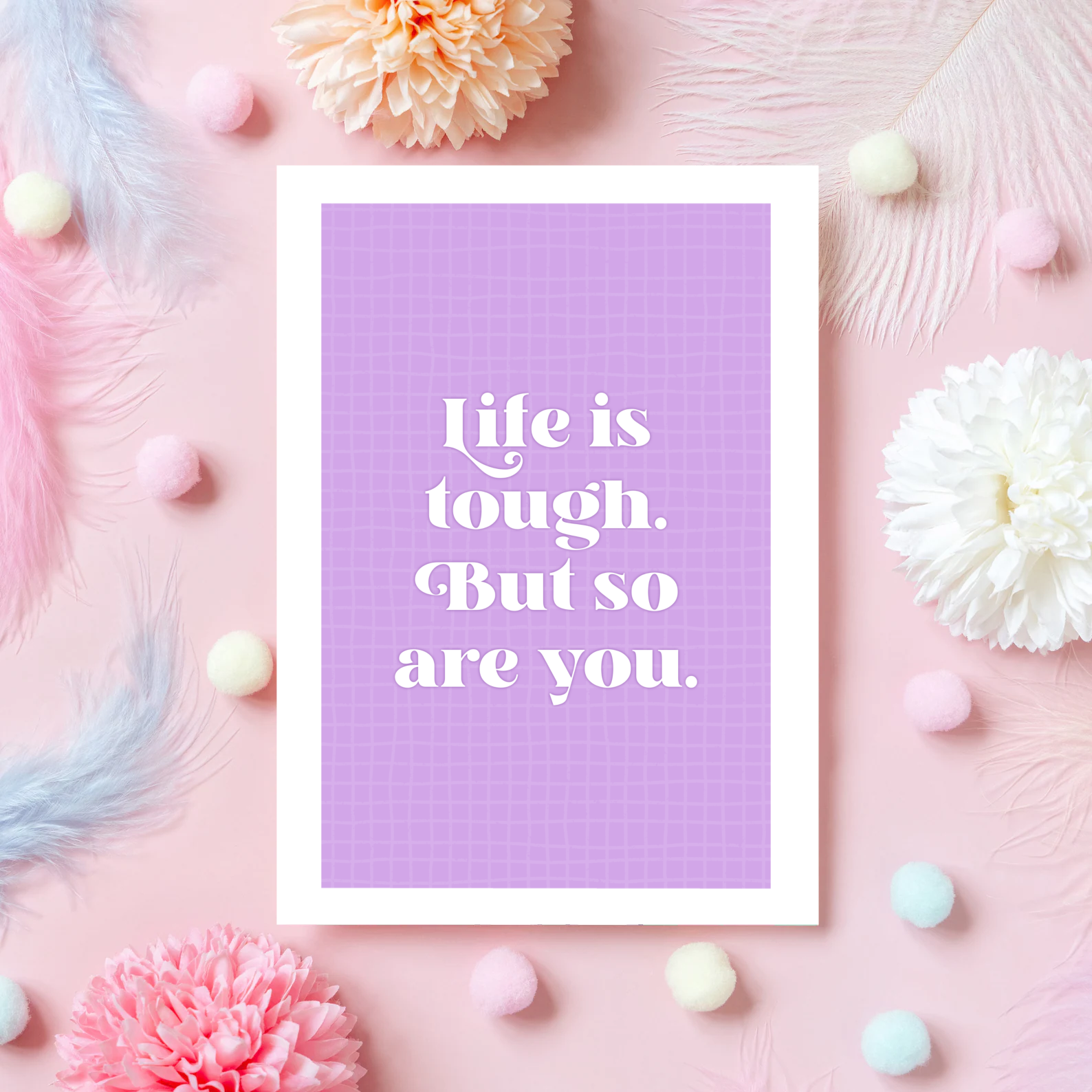 A purple card, with the quote 'life is tough, but so are you' on the front.