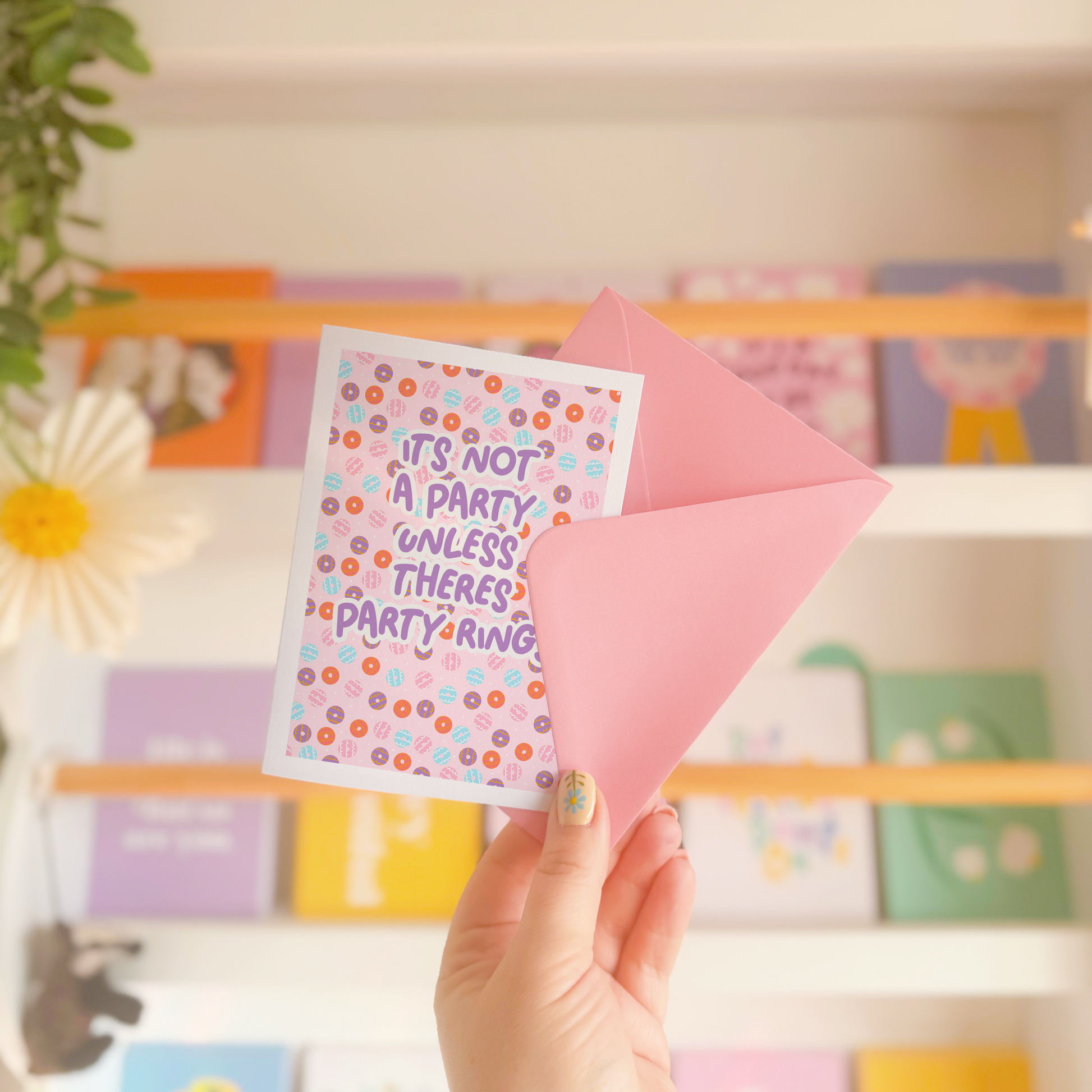 A birthday card, with a party ring pattern, and the text says 'it's not a party unless there's party rings'