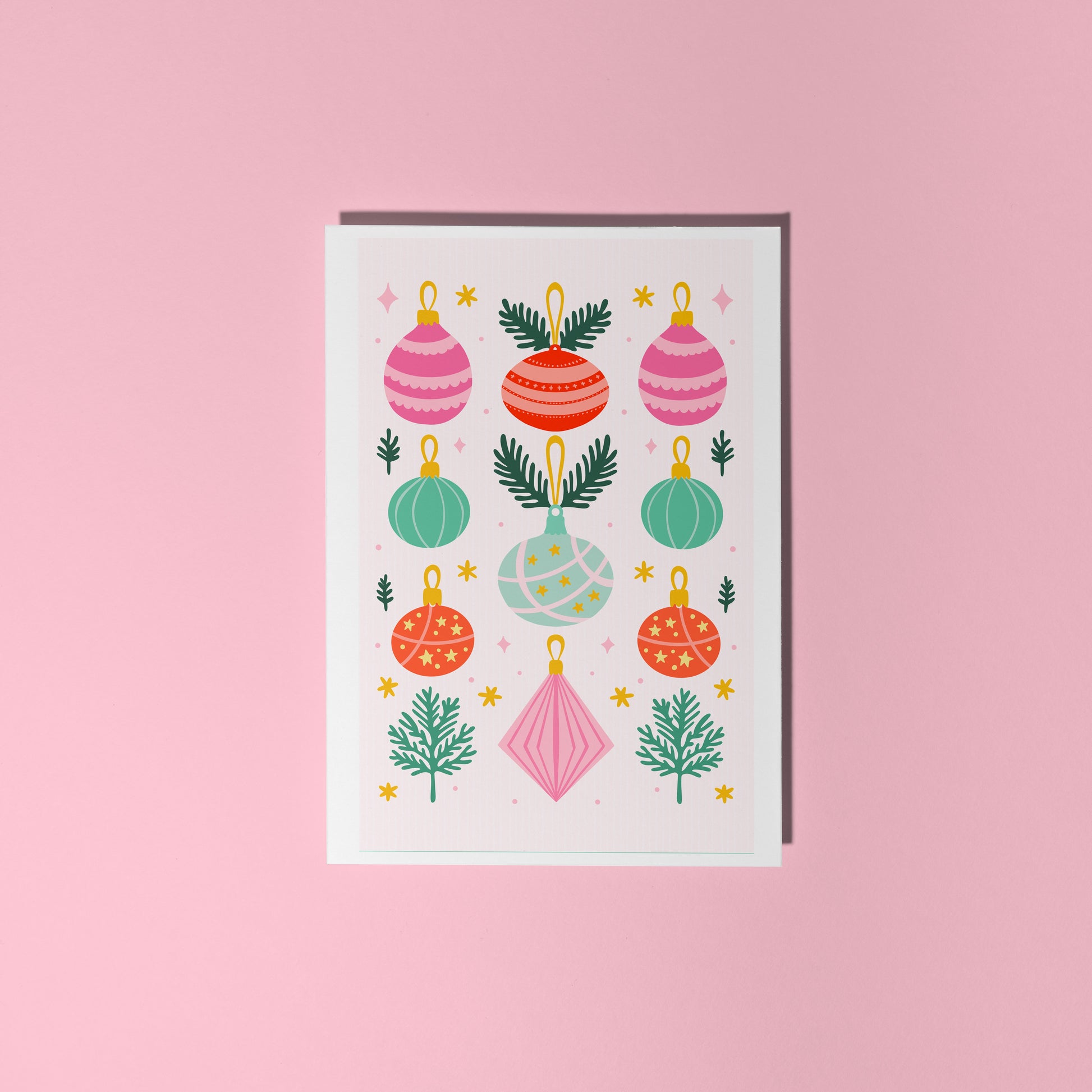 A Christmas card with 9 different coloured baubles on the front, in pastel tones.