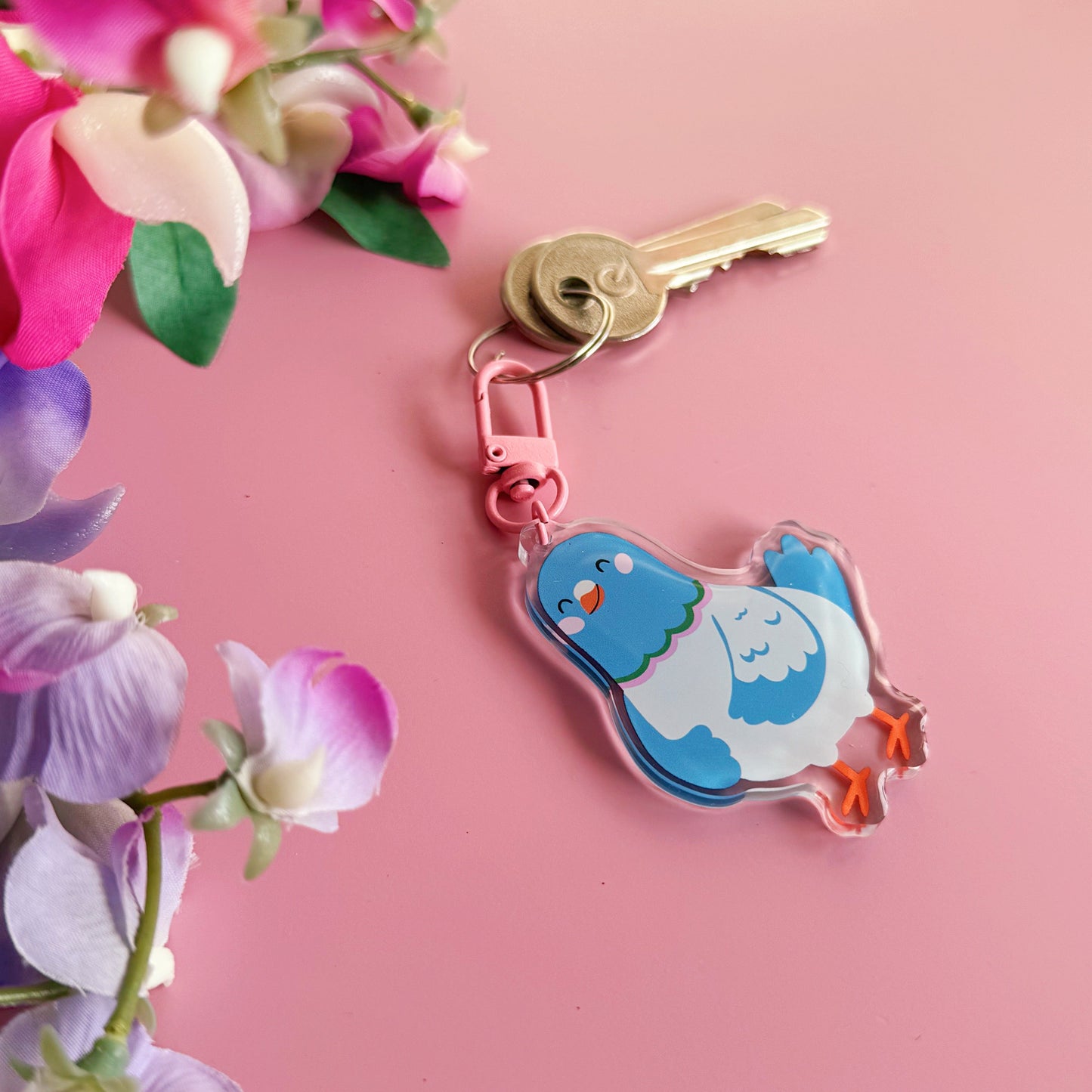 A cute blue pigeon keyring, with a pink clasp.