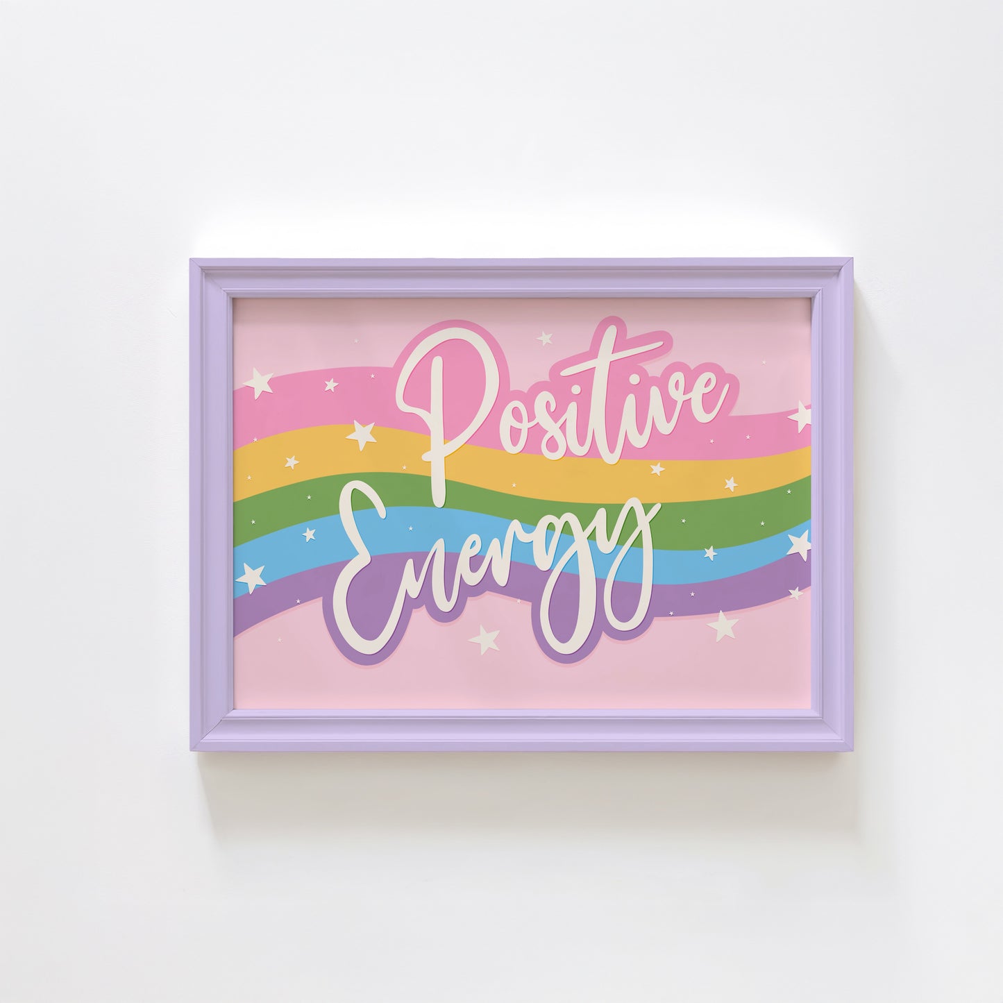 A bright print, with a pink, yellow, green blue and purple wave across the centre and the words 'positive energy' hand written in white across the top.