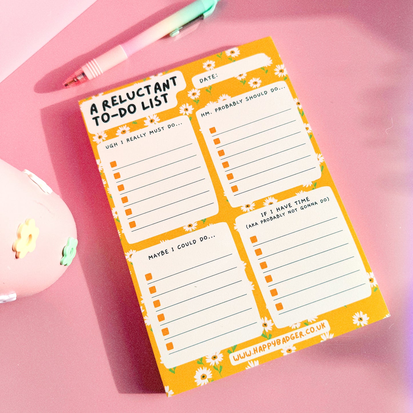 An image of an A5 yellow notepad, with funny headed sections. The notepad has a yellow floral background and four sections.