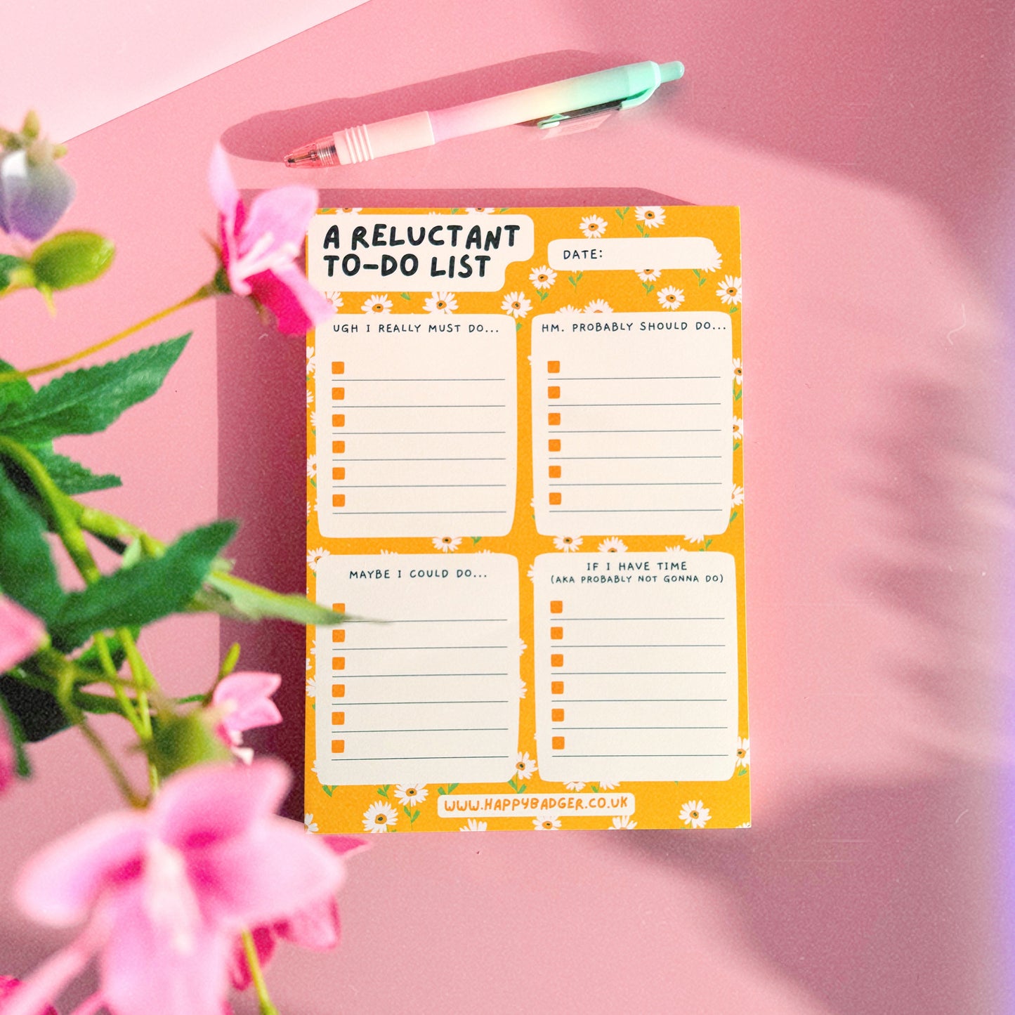 An image of an A5 yellow notepad, with funny headed sections. The notepad has a yellow floral background and four sections.
