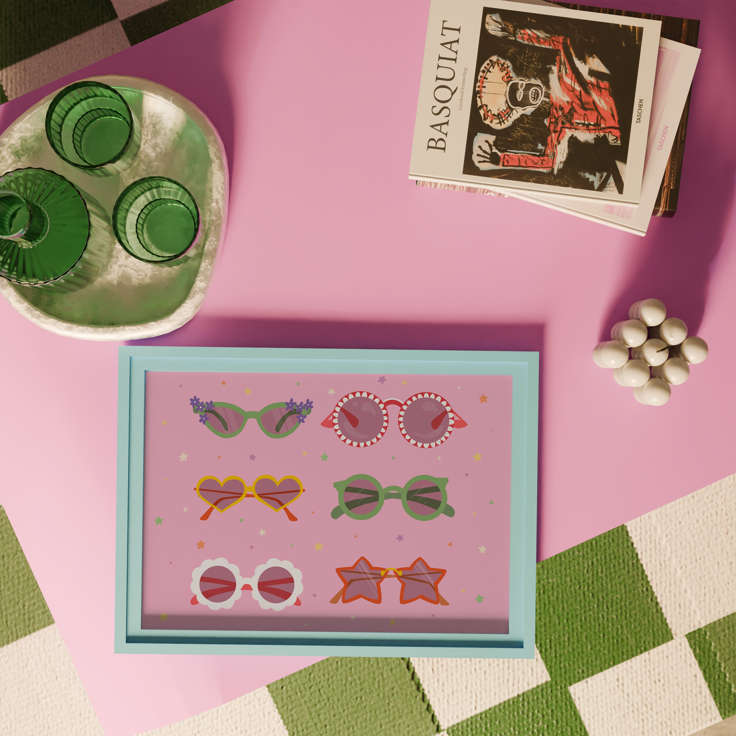 A pink print, with 6 pairs of different colourful sunglasses illustrated, in all different shapes. The background of the print is decorated with little colourful star illustrations.