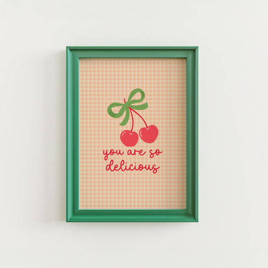 An orange gingham background print, with an illustration of red cherries tied together with a green bow, and the quote saying 'you are so delicious' below.