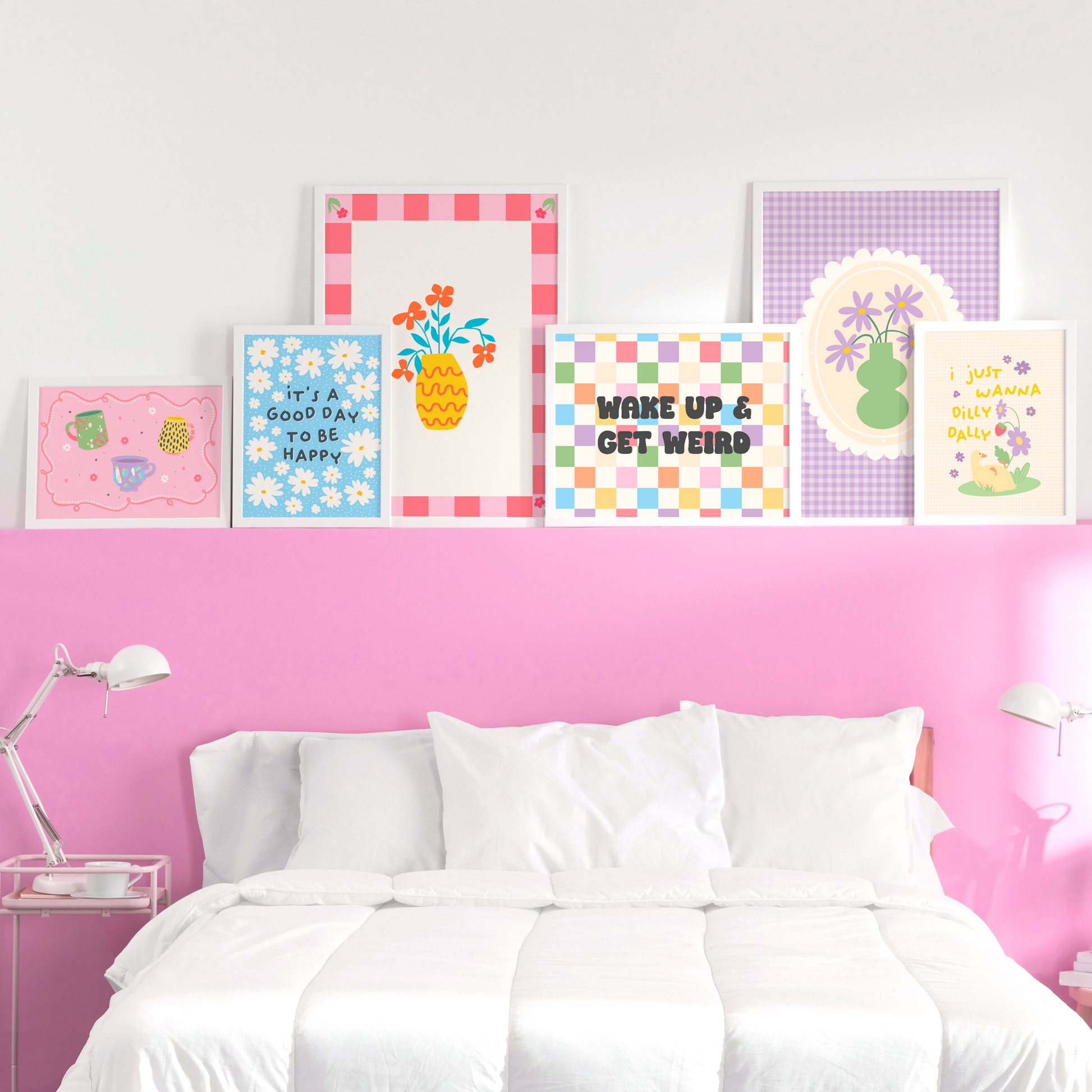 A collection of bright and colourful prints shown above a bed frame.