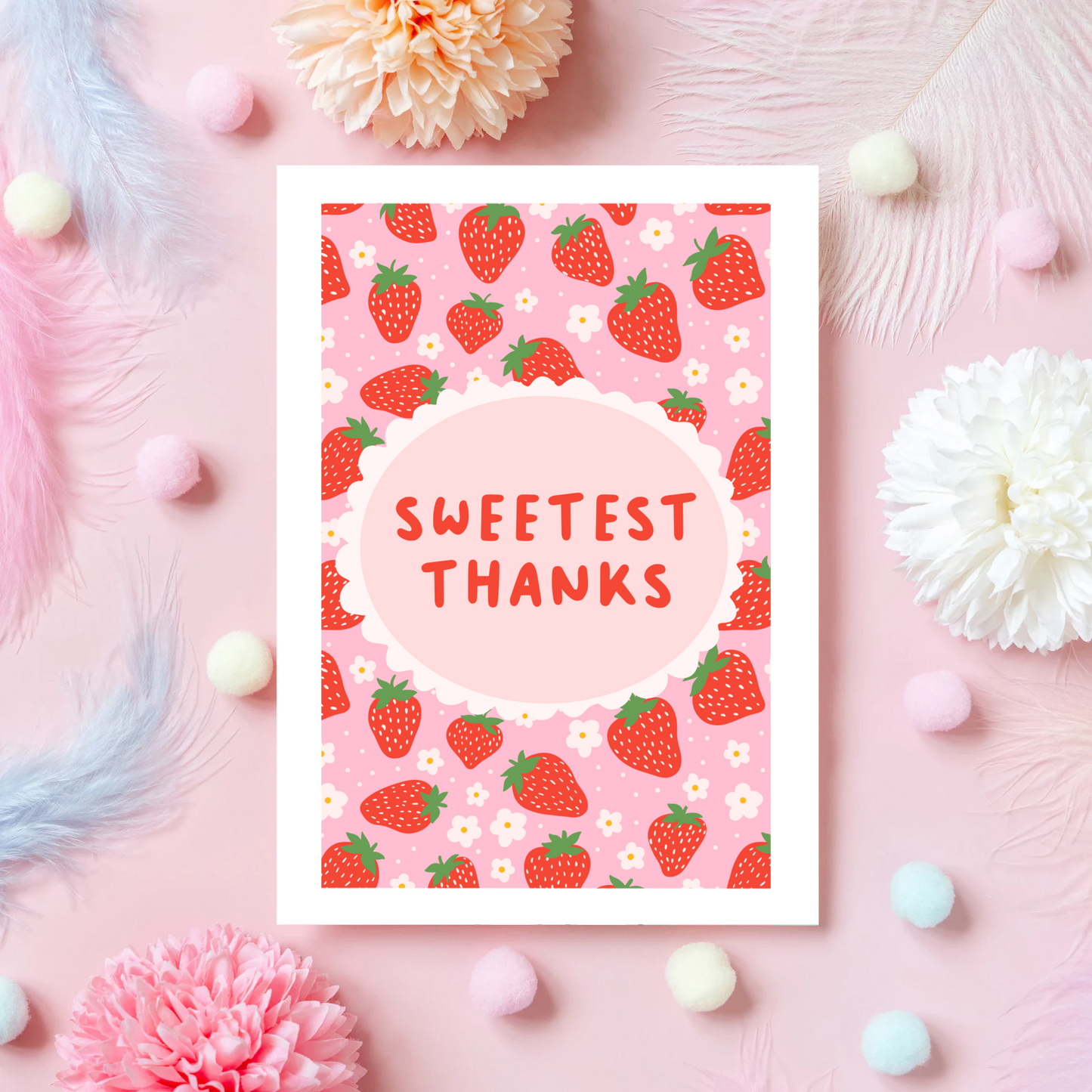 A thank you card with a strawberry pattern, and a small oval in the centre with the text 'Sweetest Thanks' in the centre.