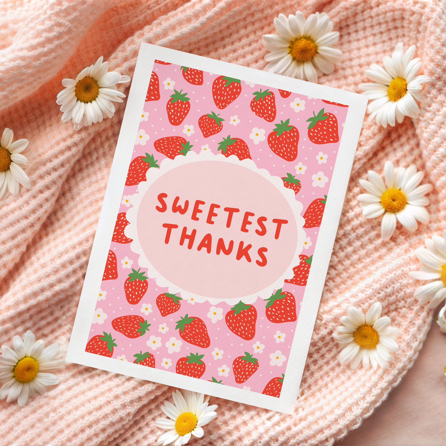 A thank you card with a strawberry pattern, and a small oval in the centre with the text 'Sweetest Thanks' in the centre.