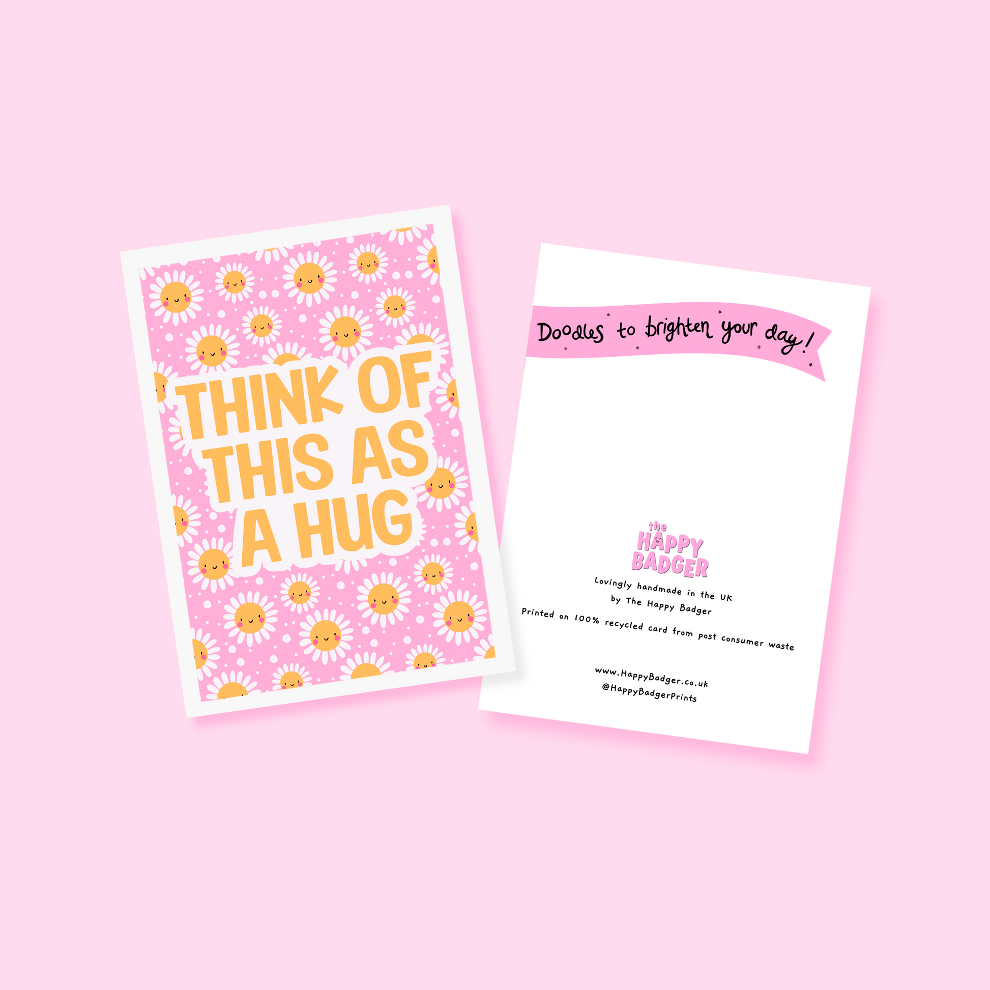 A bright pink and yellow greetings card, with a smiling daisy pattern. The text on the card reads 'think of this as a hug'.