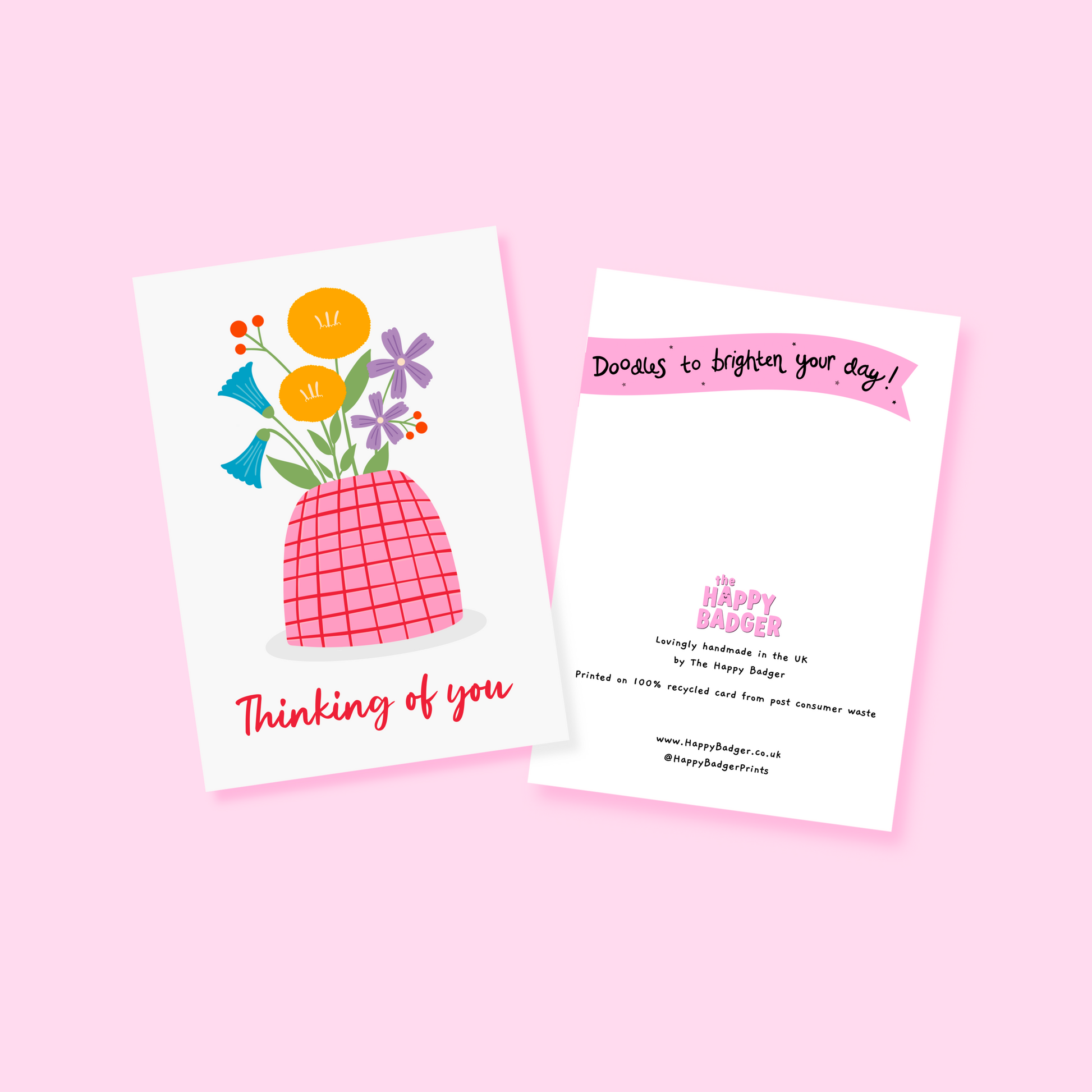 A card with a vase of colourful flowers, on a white background, with red hand written text underneath saying 'thinking of you'.