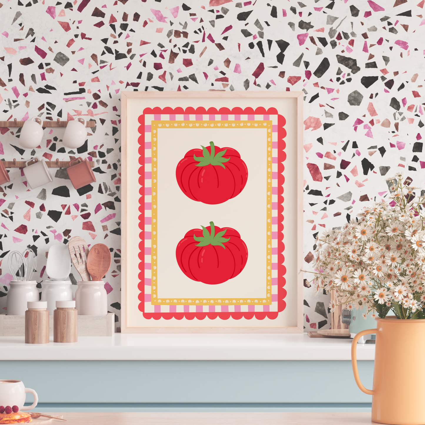 Kitchen counter with a decorative print of red tomatoes on a colorful wall.