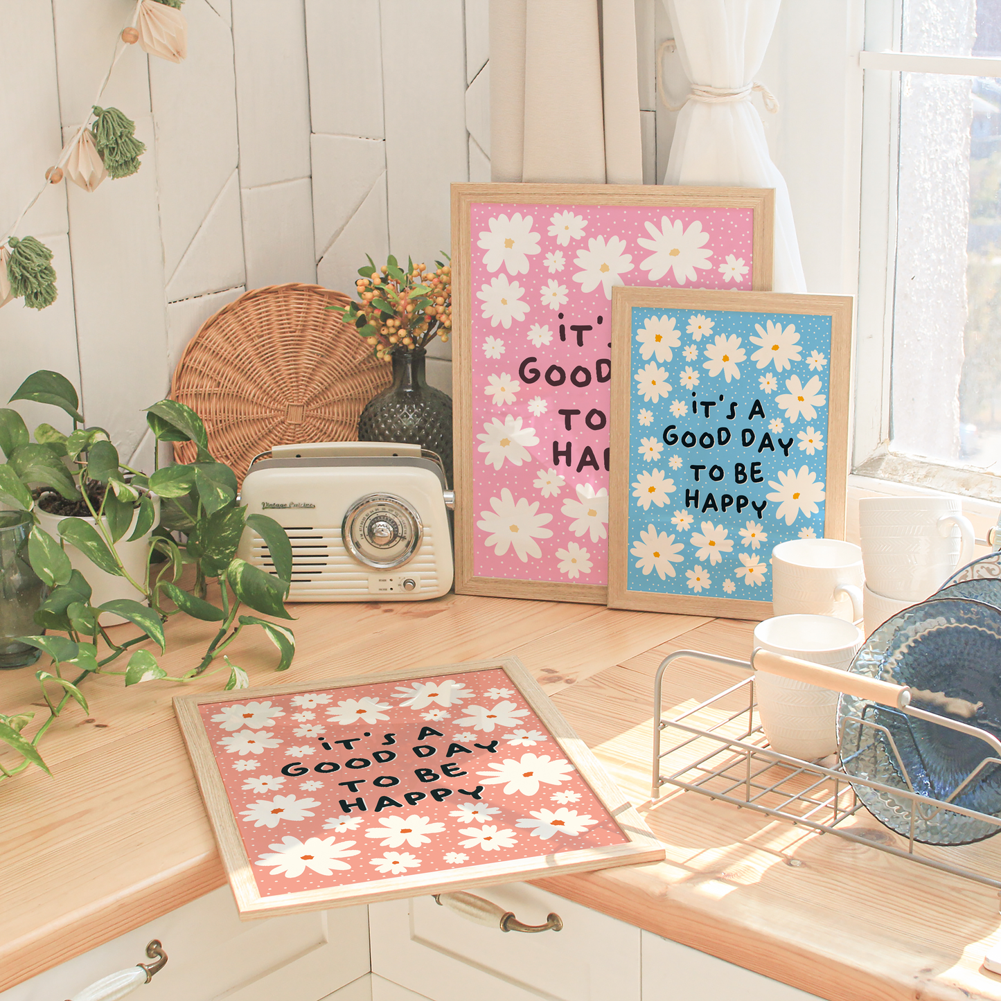 a good day to be happy prints, shown in pink, blue and orange.