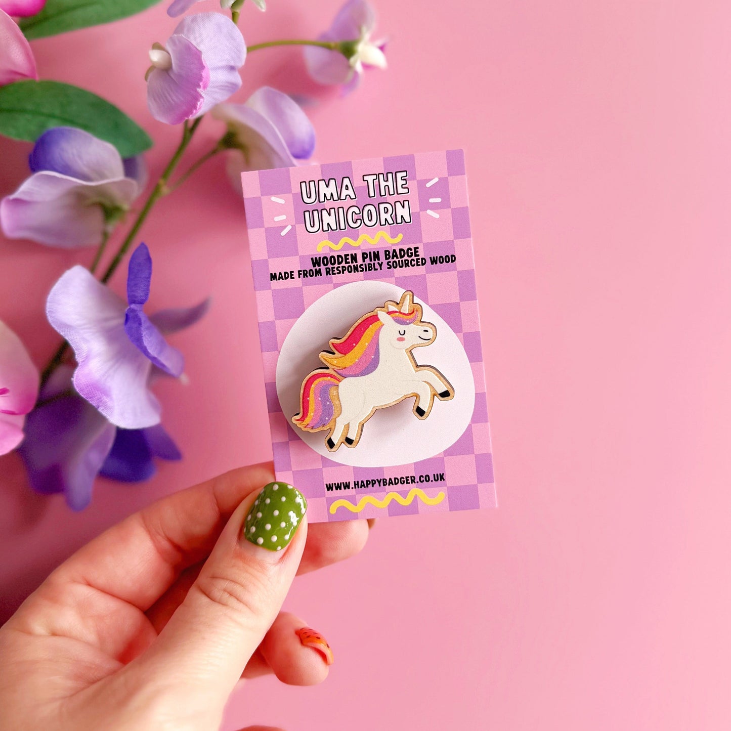 An adorable unicorn wooden pin badge with multicoloured rainbow mane and tail. Shown on a coordinating backing card.
