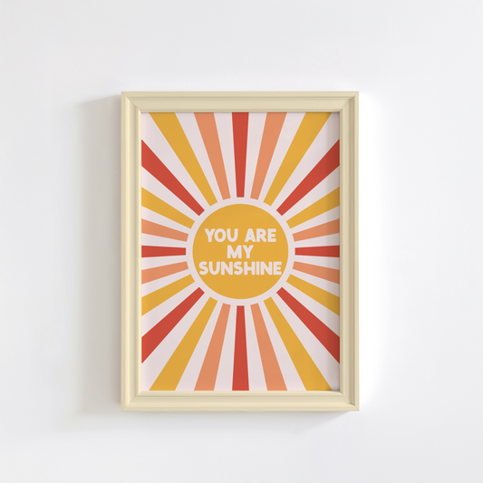 A fun quote print with text saying you are my sunshine, on a star burst background in orange yellow and red.