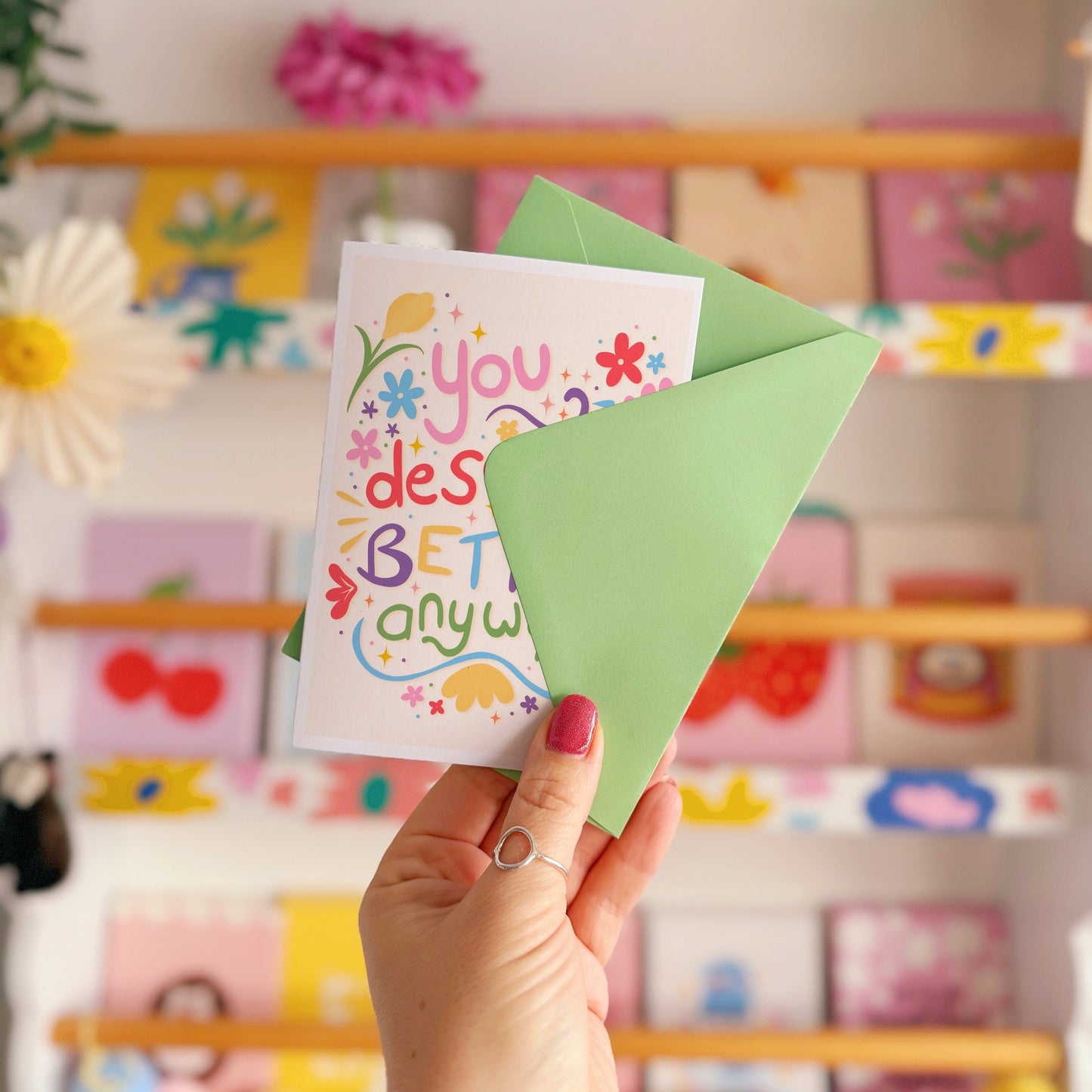 A colourful hand drawn card, which says 'you deserved better anyway', surrounded by colourful doodles and flowers.
