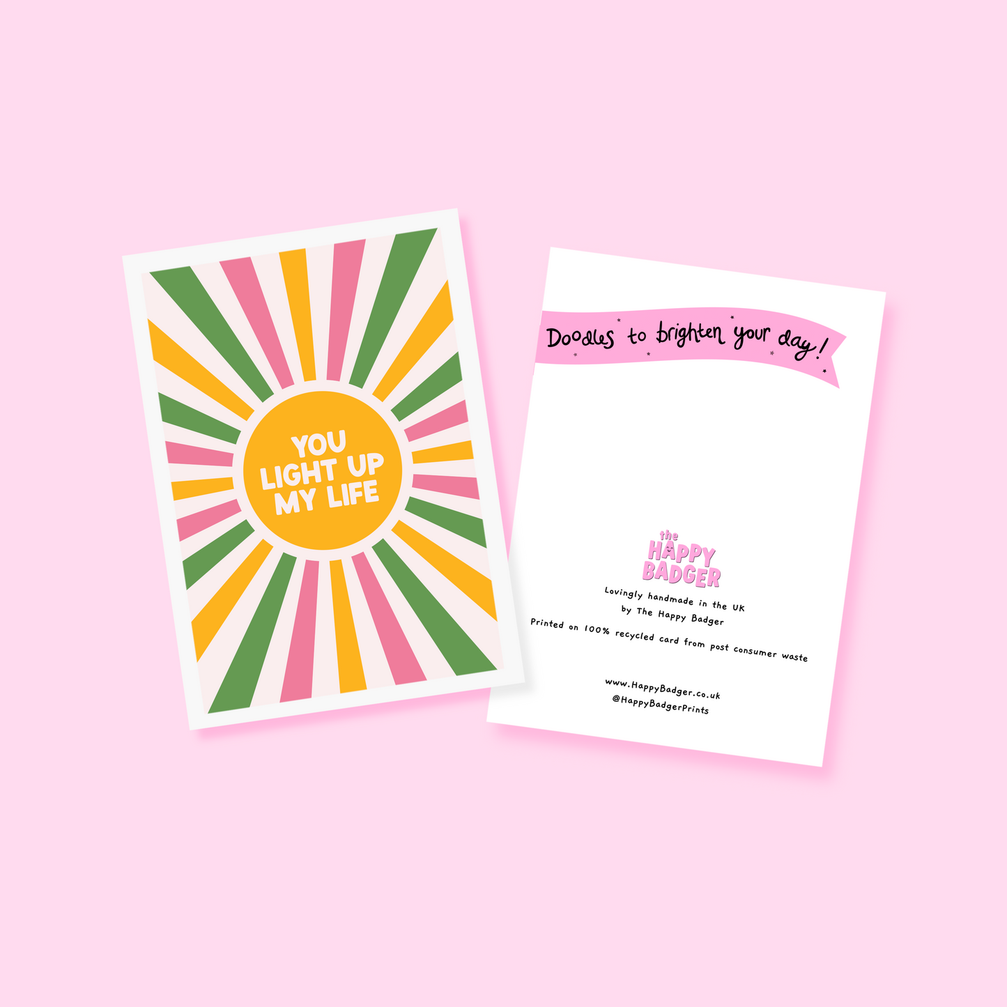 a greetings card with a colourful pink yellow and green sunburst, with the words you light up life in the centre.