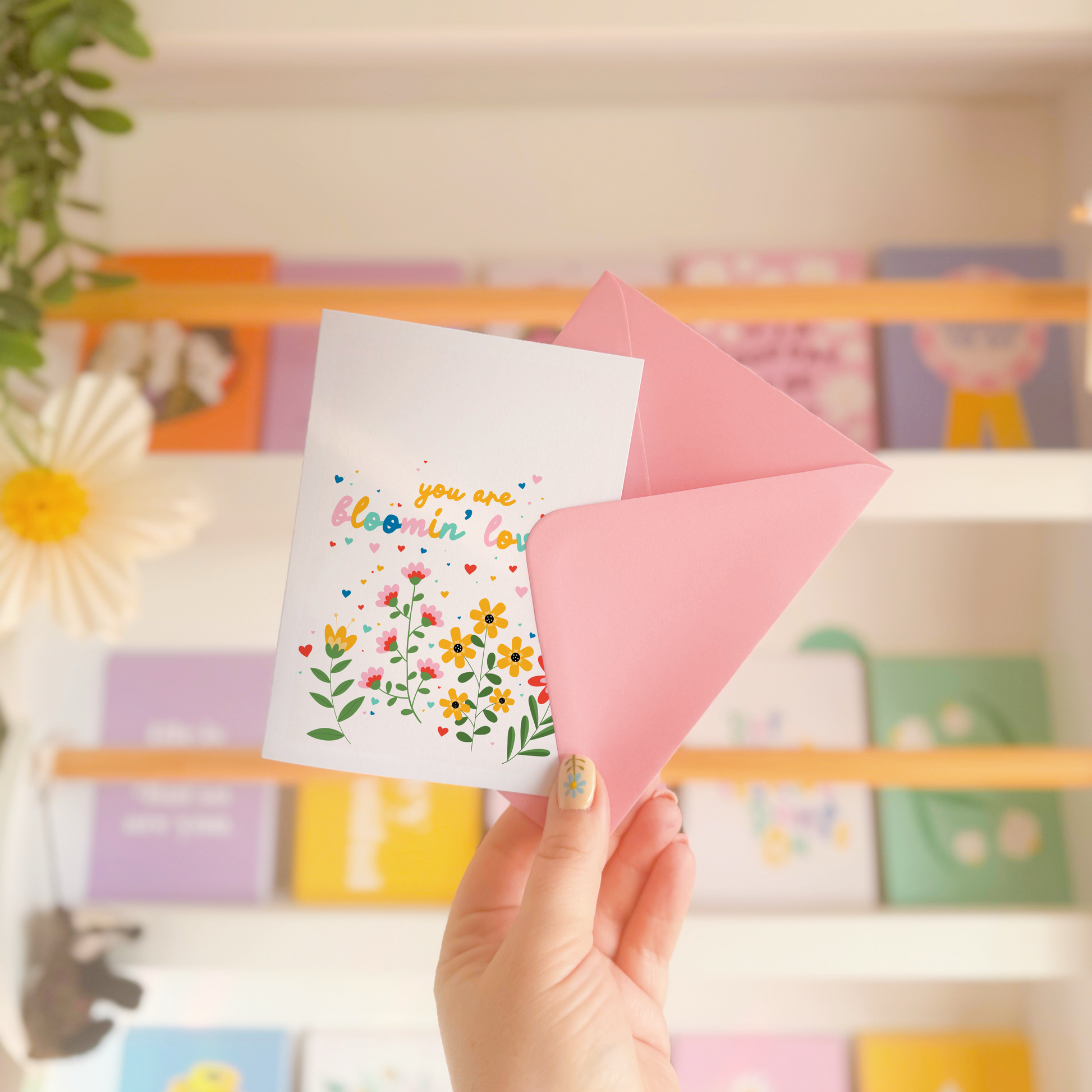 A card with floral illustrations and text that says you are bloomin' lovely