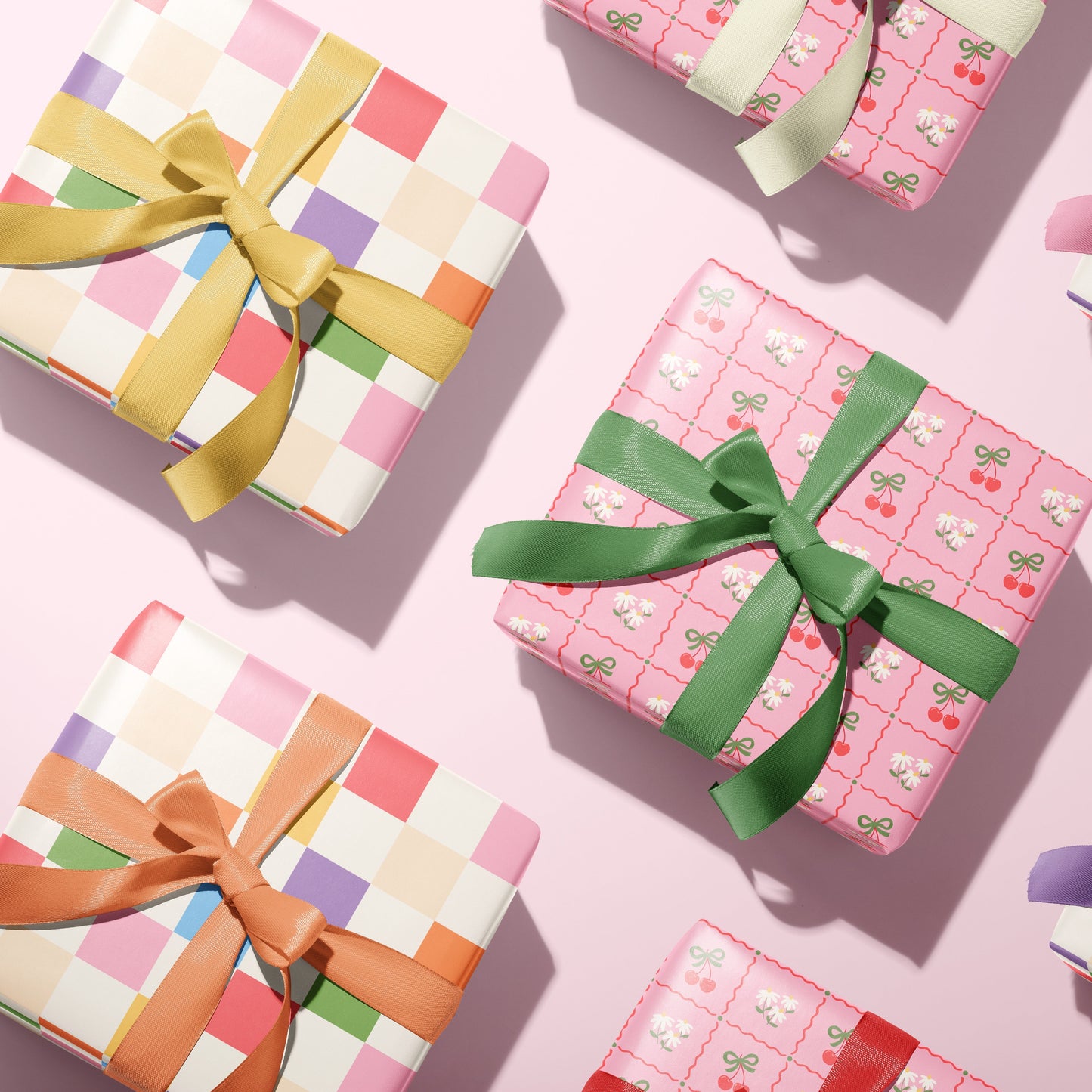 a multi coloured gift wrap, and a spring cherry pattern gift wrap, shown from above.
