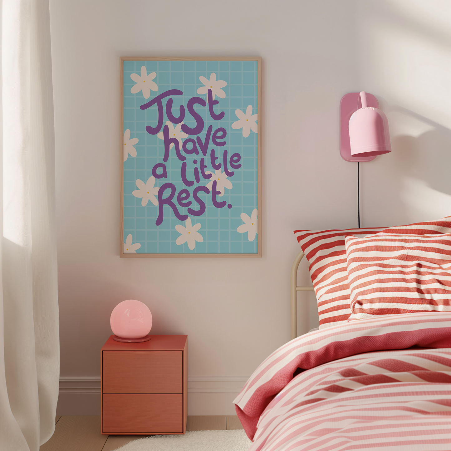Bedroom with pink and red striped bedding, a nightstand with a pink lamp, and a wall art piece with motivational text.