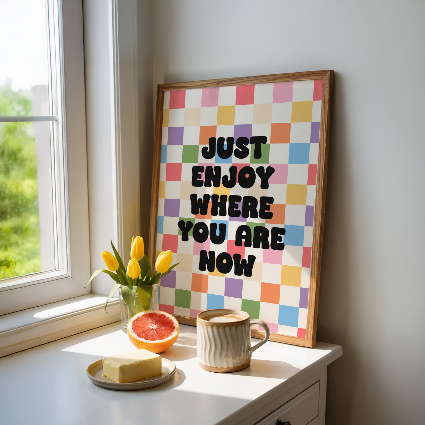 A colourful checkered background, with a quote saying "just enjoy where you are now".
