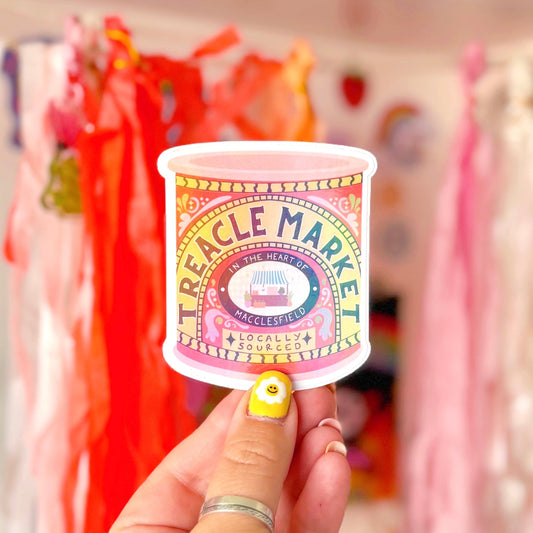 A holographic sticker of a jar of treacle, but it has been illustrated to represent the Treacle market which takes place once a month in the town of Macclesfield.