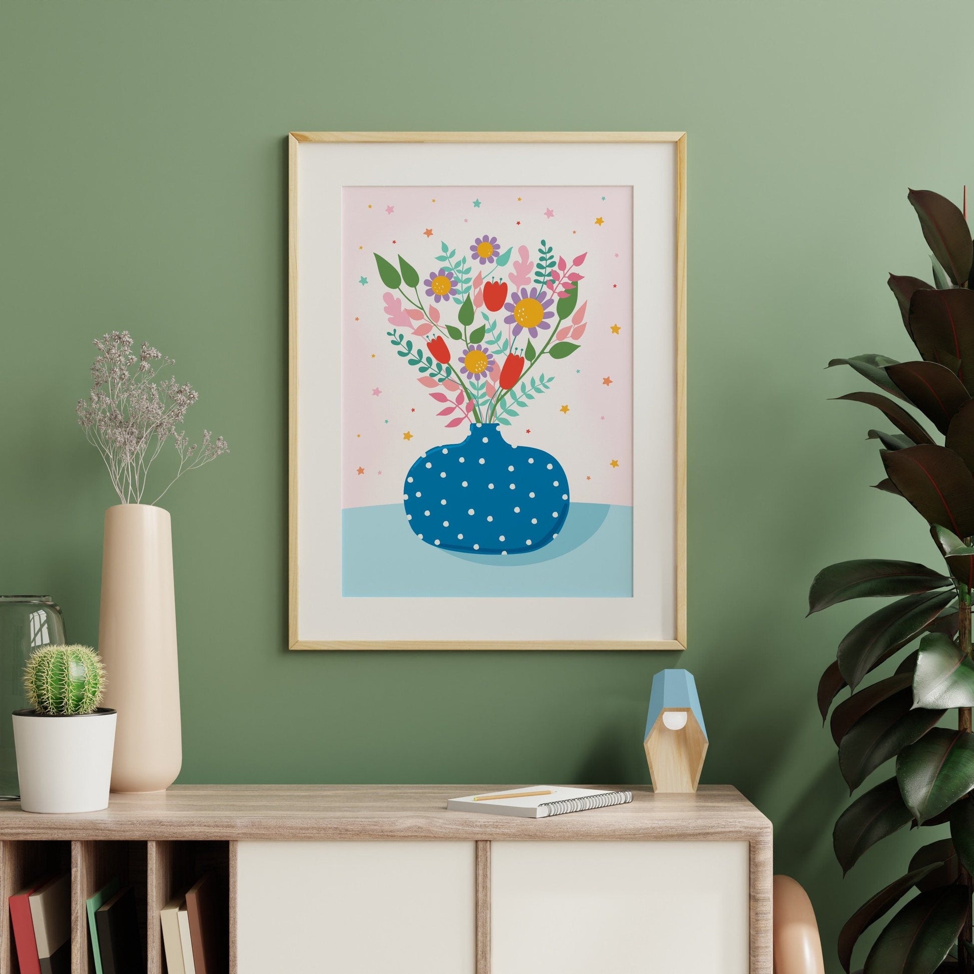 A bright blue print showing a pole dot vase with lots of vibrant hand drawn flowers in it.